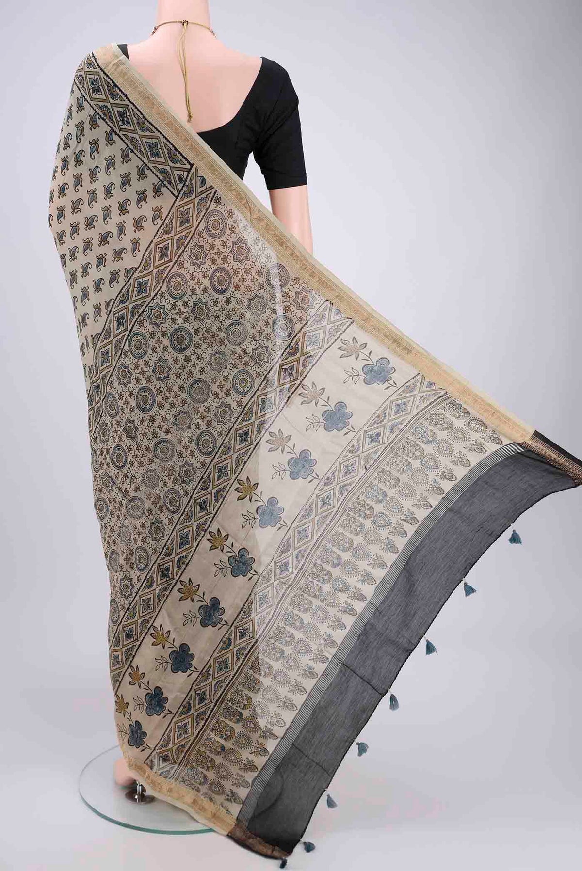 Flat view of Beige Chanderi Silk Cotton Saree with Ajrakh Print on the body and Zari Border. 