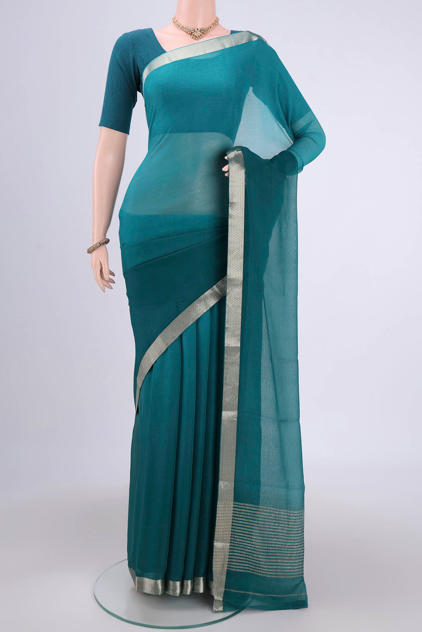 Peacock Blue Dual Tone Mysore Chiffon Saree with Plain Body and Zari Border.  displayed on a mannequin