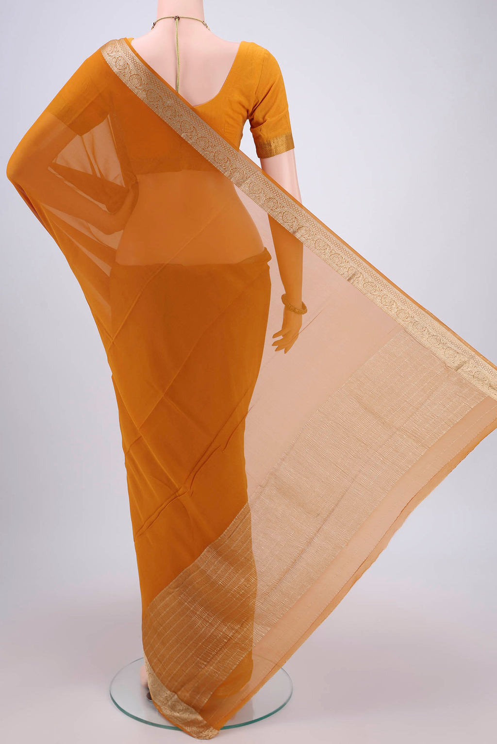 Flat view of Mustard Georgette Saree with Plain Body and Satin Border. 