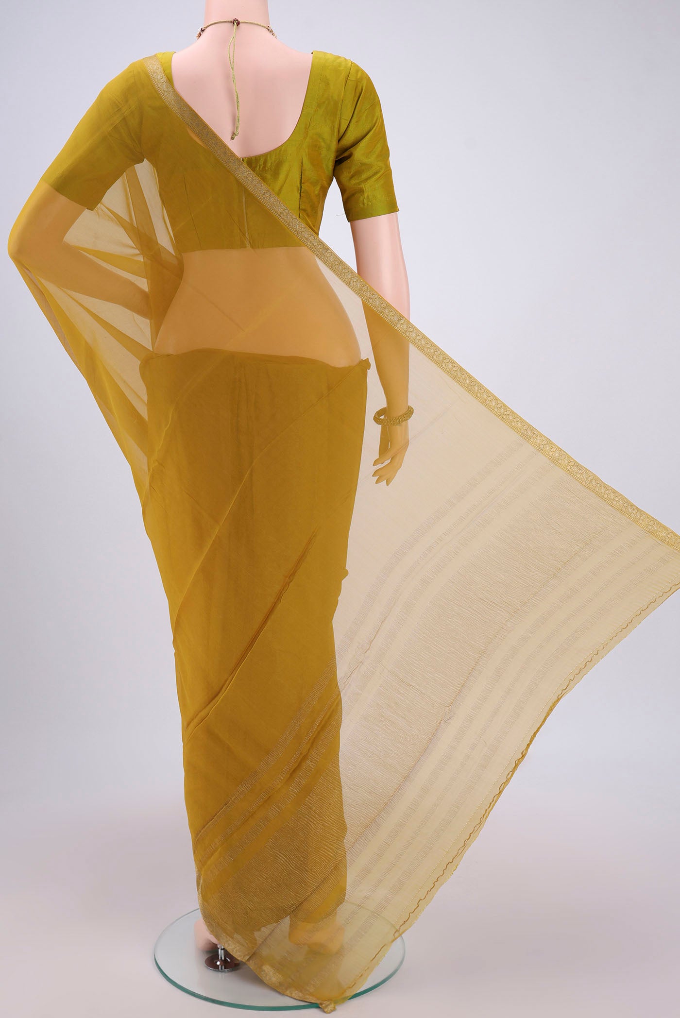 Flat view of Mehandi Green Mysore Chiffon Saree with Plain Body and Zari Border. 