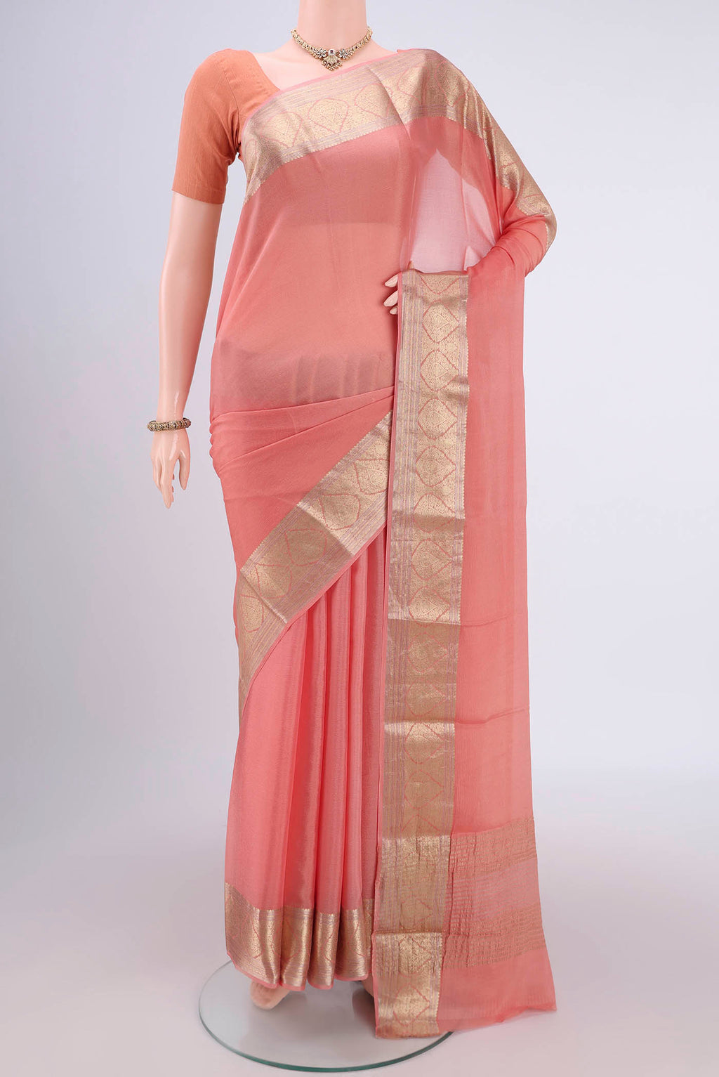 Peach Mysore Chiffon Saree with Plain Body and Zari Border.  displayed on a mannequin