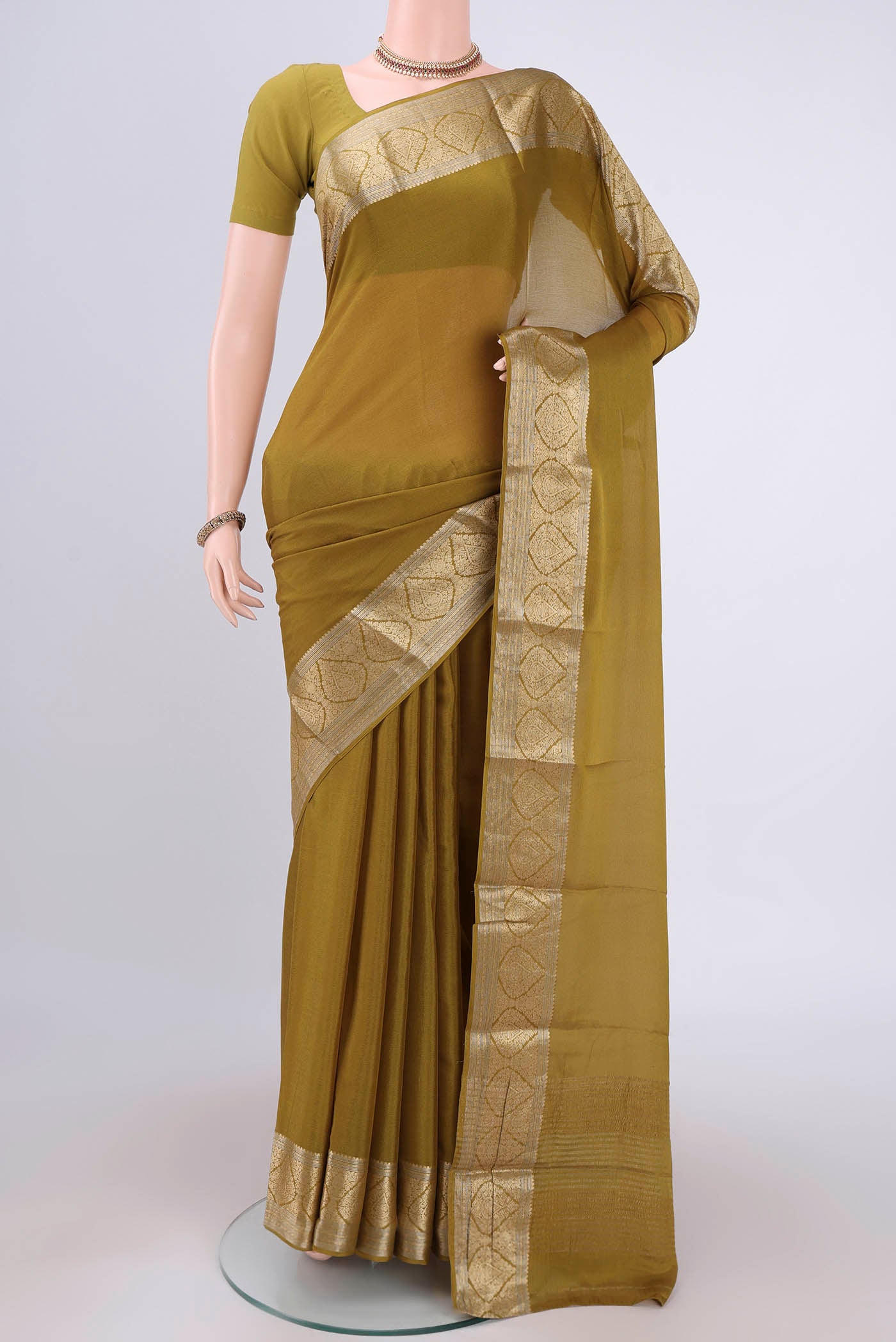 Mehandi Green Mysore Chiffon Saree with Plain Body and Zari Border.  displayed on a mannequin