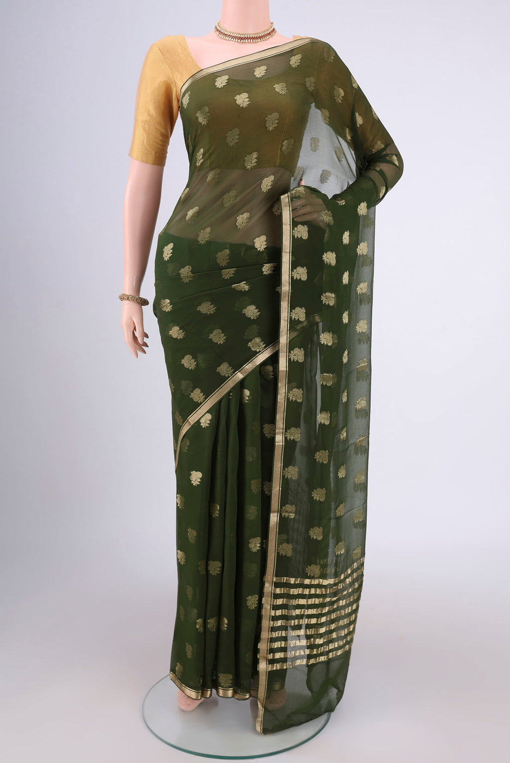 Olive Green Mysore Chiffon Saree with Zari Butta on the body and Zari Border.  displayed on a mannequin