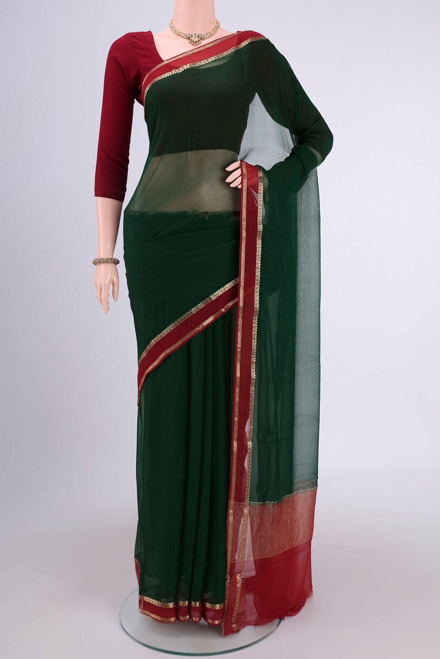 Bottle Green Dual Tone Mysore Chiffon Saree with Plain Body and Zari Border.  displayed on a mannequin