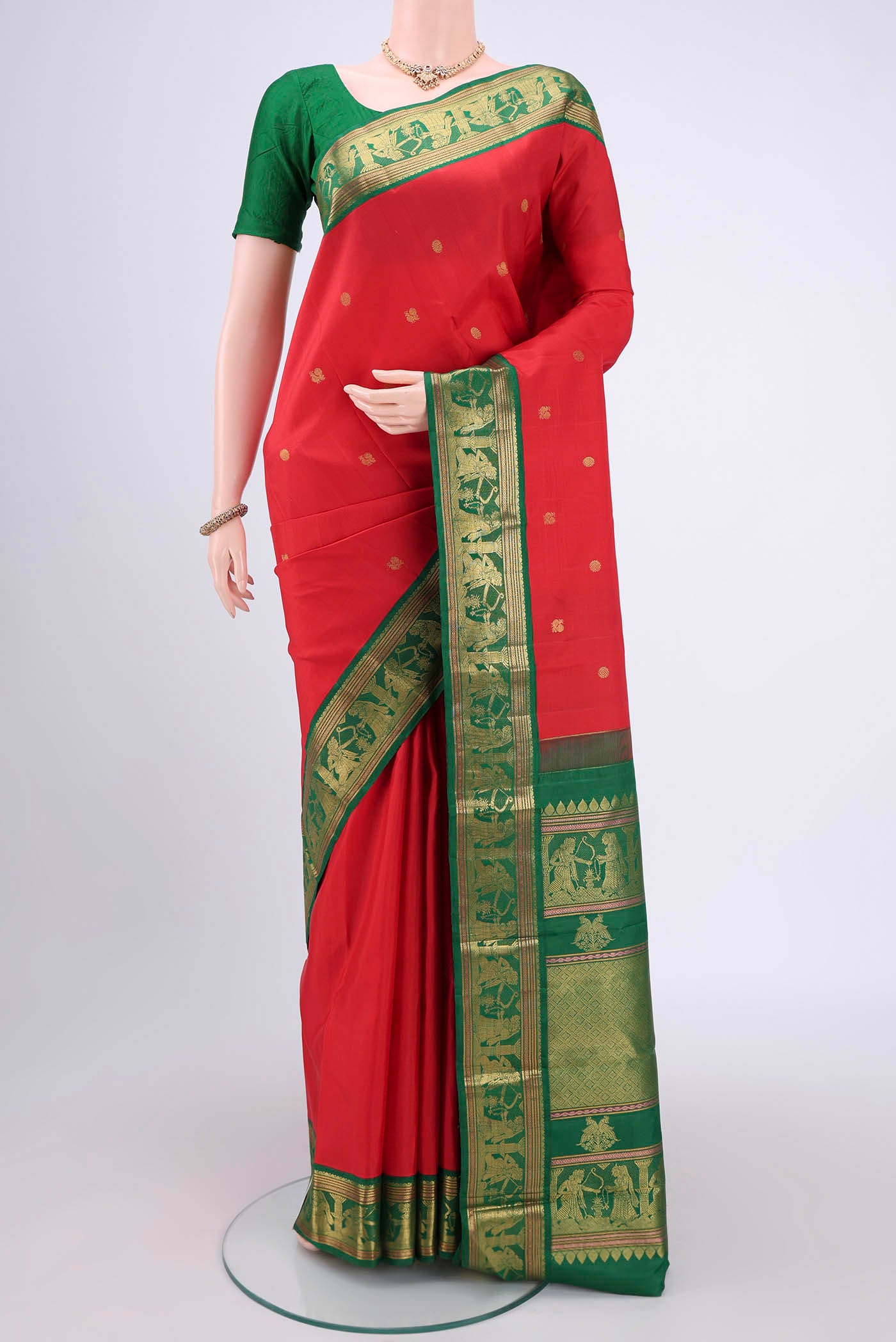 Red Dual Tone Kanjivaram Silk Saree with Zari Butta on the body and Zari Border.  displayed on a mannequin