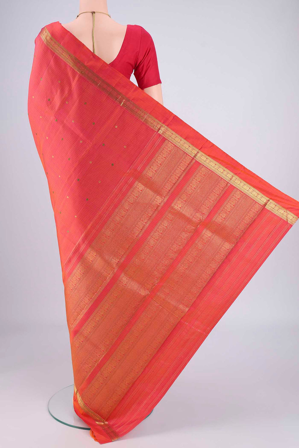 Flat view of Brick Orange Kanjivaram Silk Saree with Zari And Thread Butta on the body and Zari Border. 