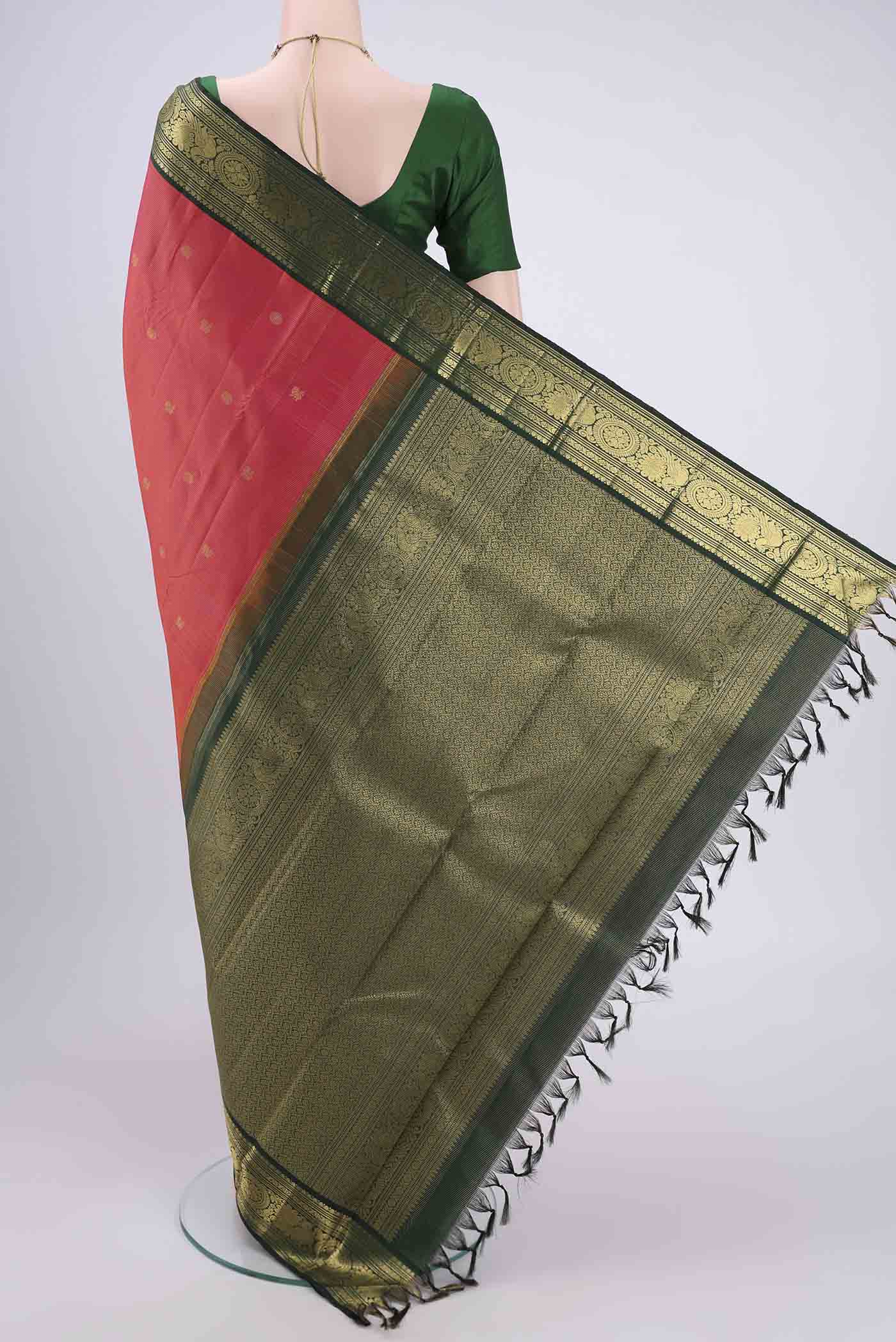 Flat view of Brick Orange Kanjivaram Silk Saree with Zari Butta on the body and Zari Border. 