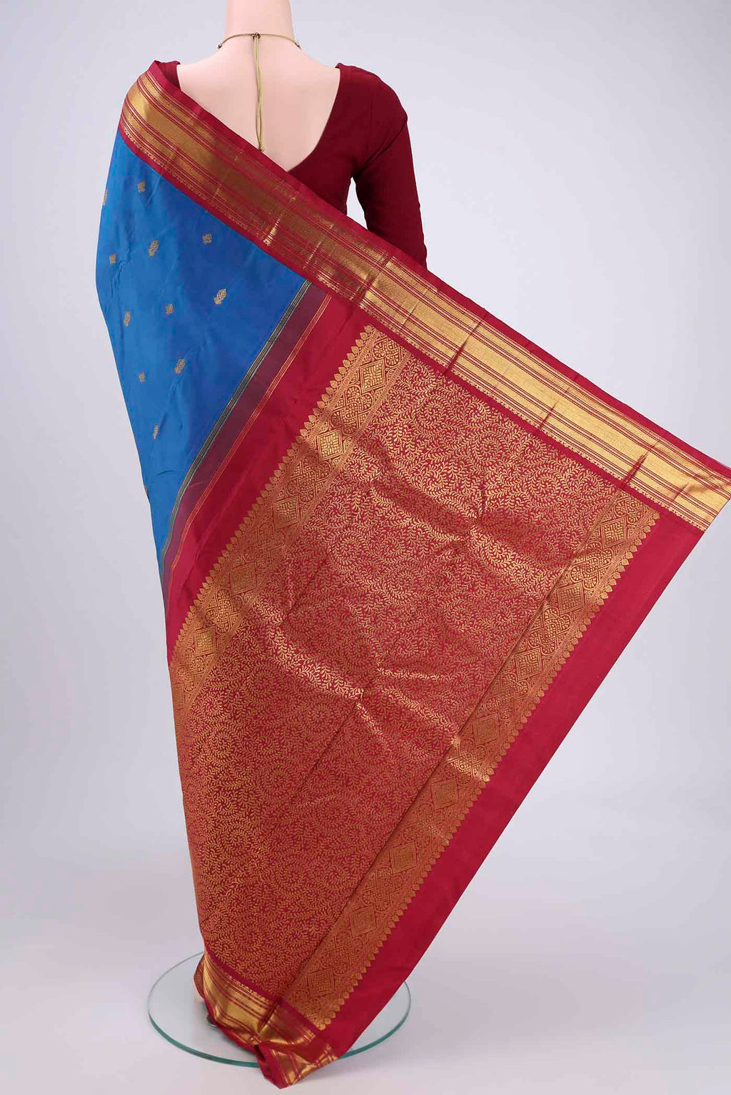Flat view of Blue Kanchipuram Silk Saree with Zari Butta on the body and Zari Border. 