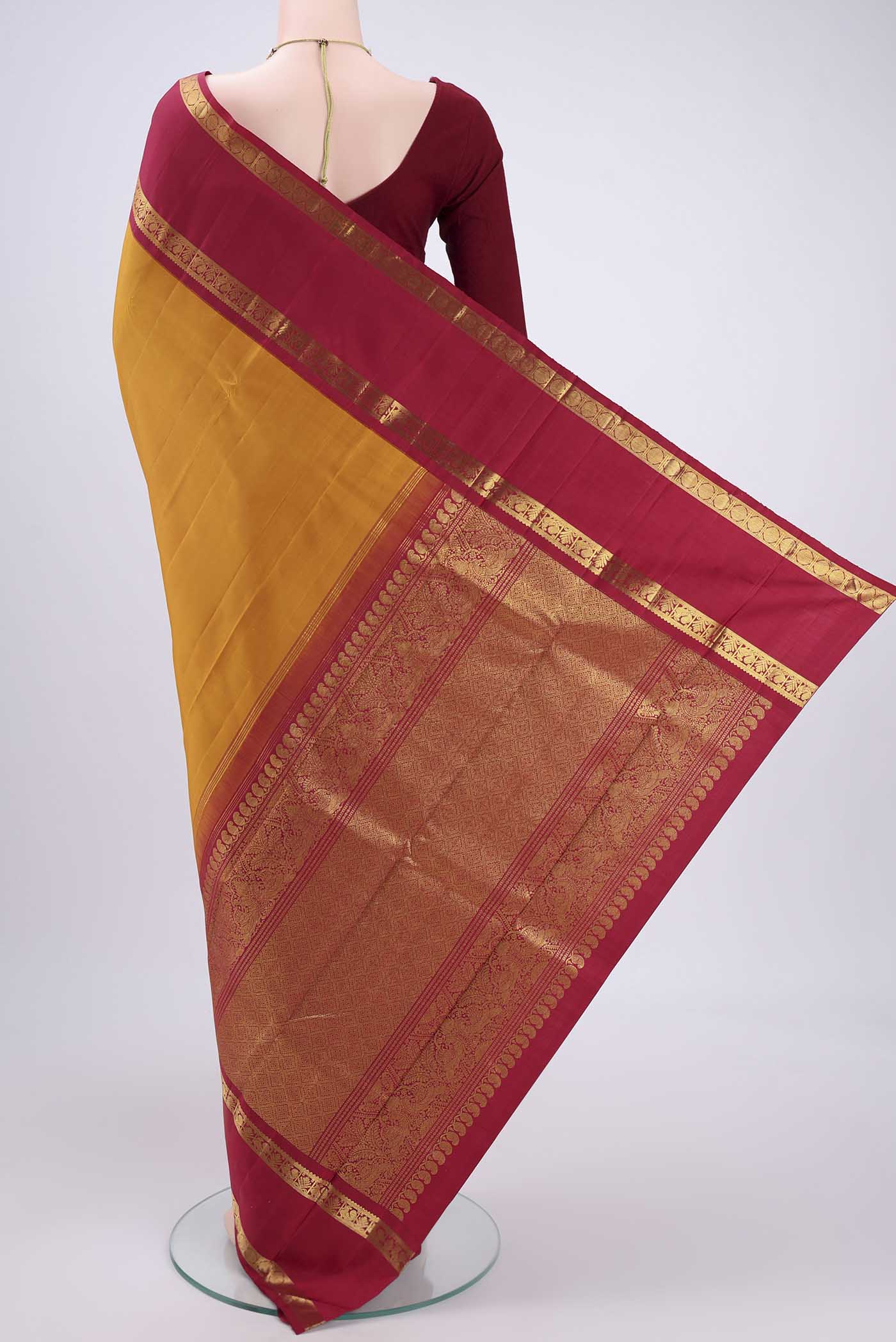 Flat view of Mustard Kanchipuram Silk Saree with Plain Body and Zari Border. 