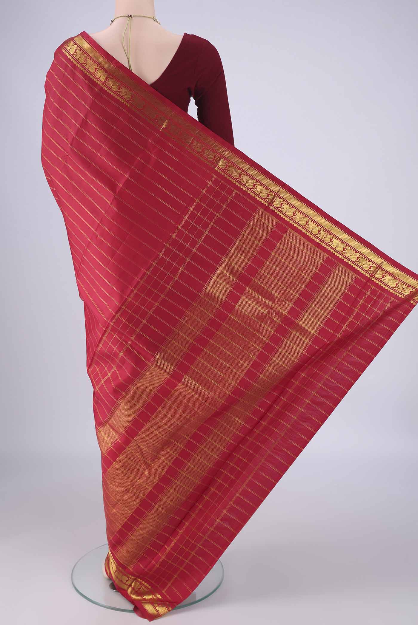 Flat view of Red Kanchipuram Silk Saree with Stripes on the body and Zari Border. 