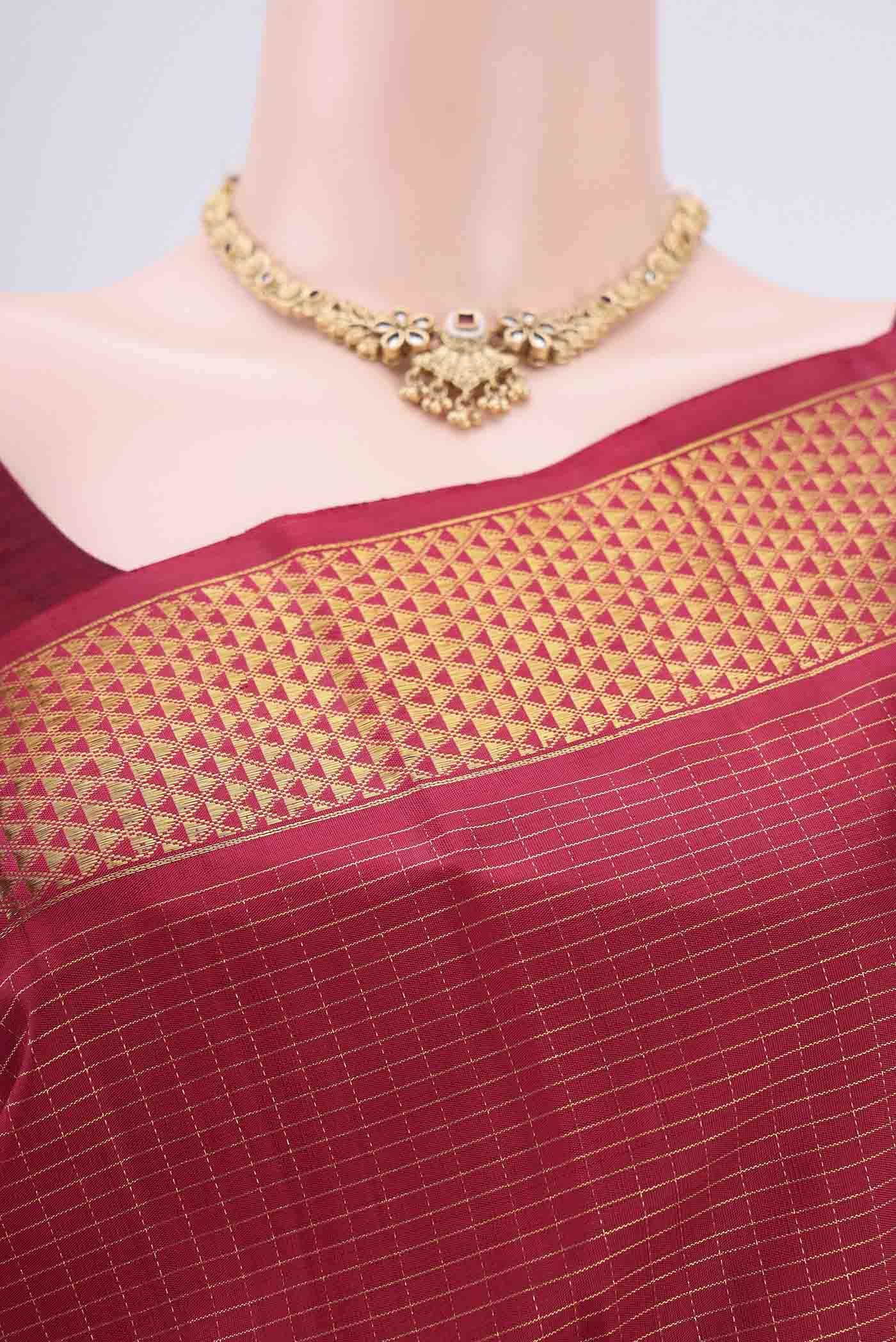 Border image of Maroon Kanchipuram Silk Saree with Checked design on the body and Zari Border. 