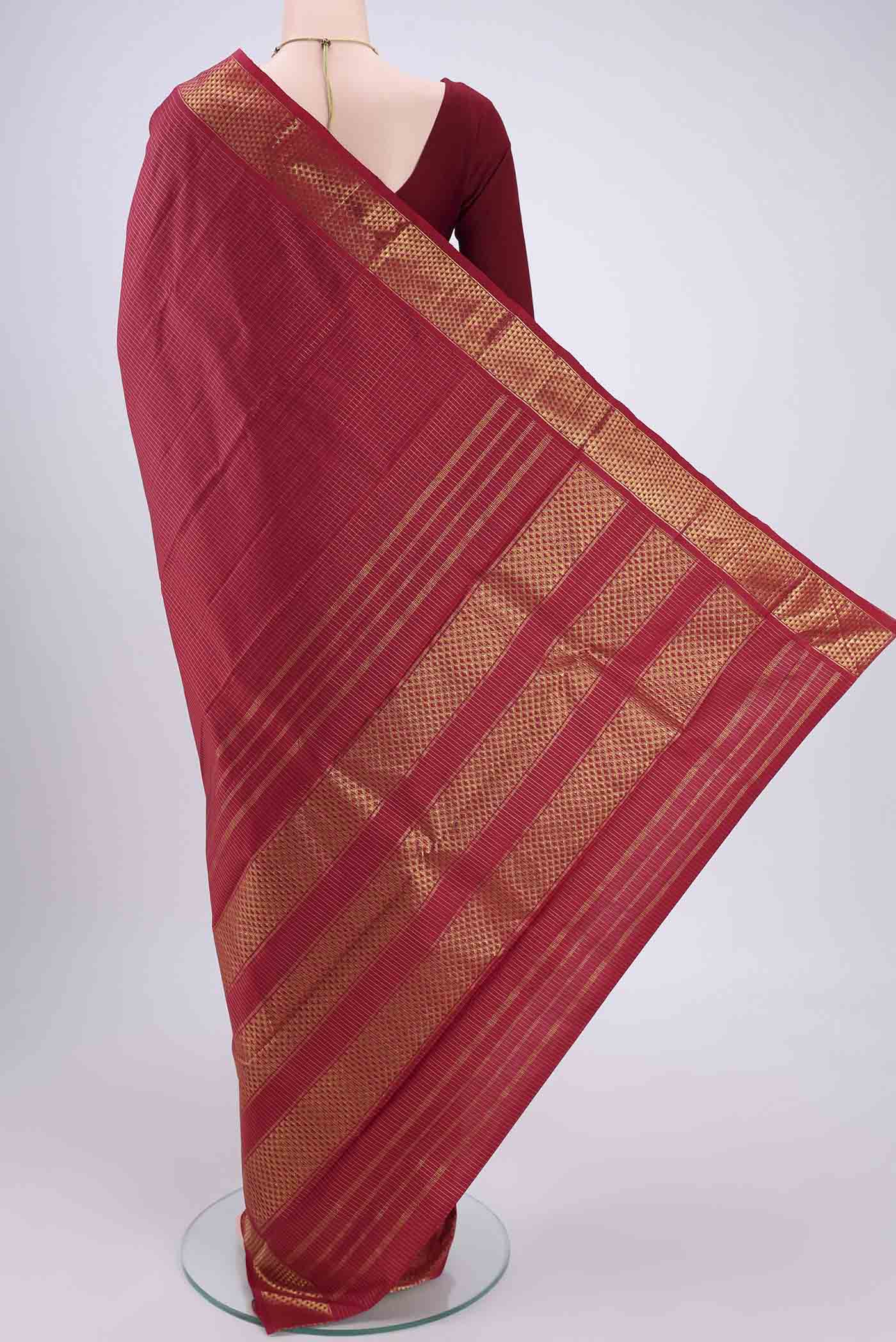 Flat view of Maroon Kanchipuram Silk Saree with Checked design on the body and Zari Border. 