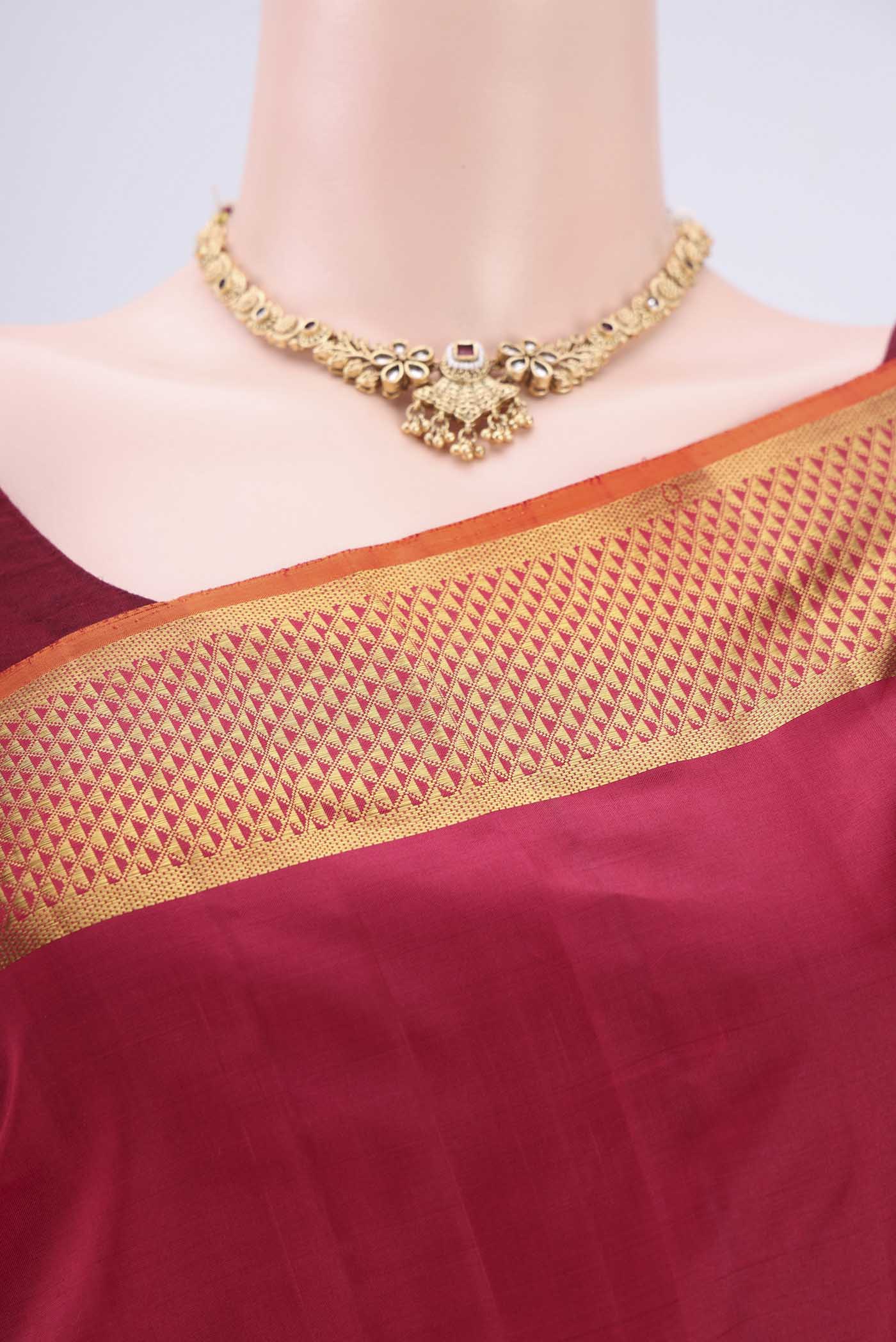 Border image of Maroon Kanchipuram Silk Saree with Plain Body and Zari Border. 