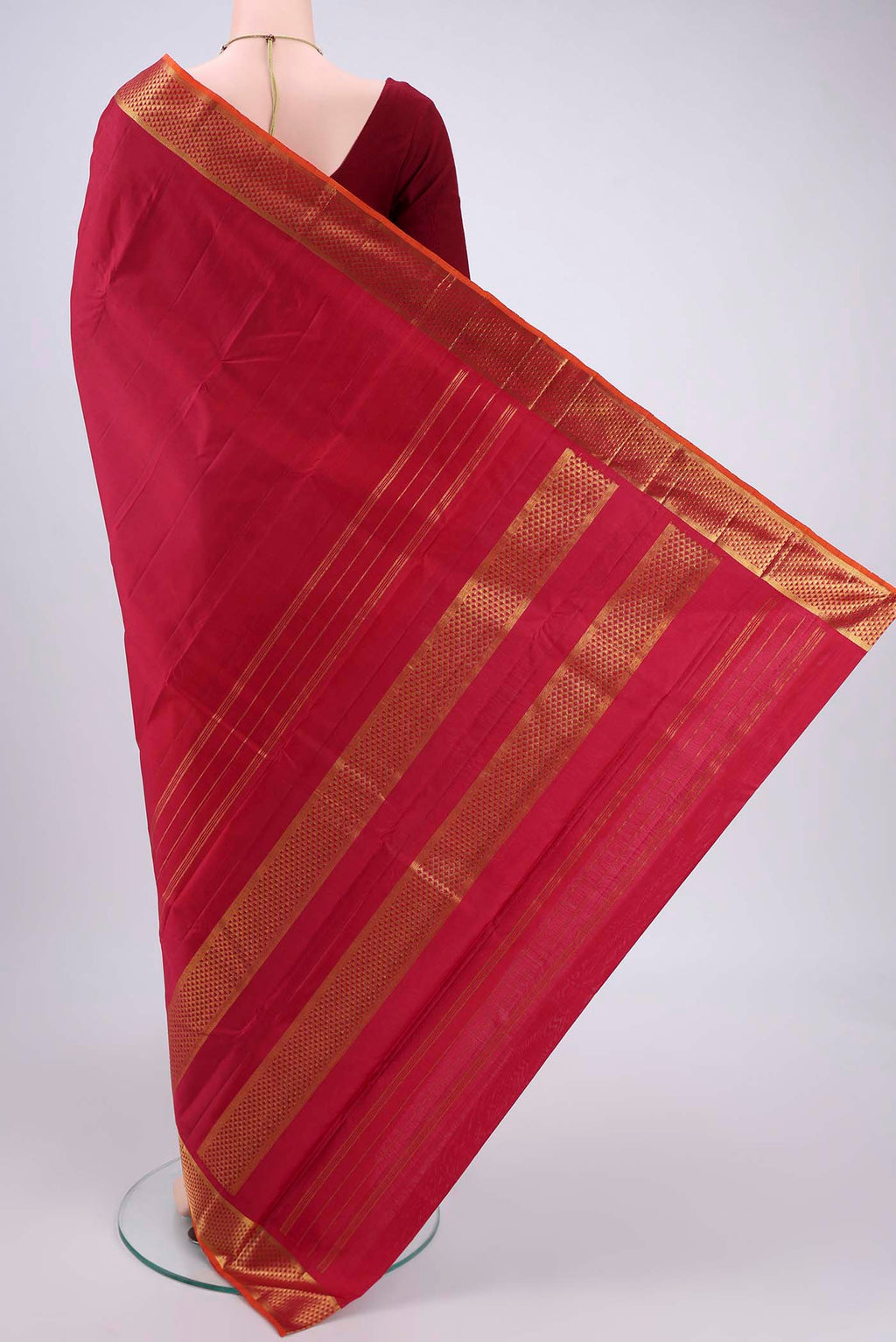 Flat view of Maroon Kanchipuram Silk Saree with Plain Body and Zari Border. 