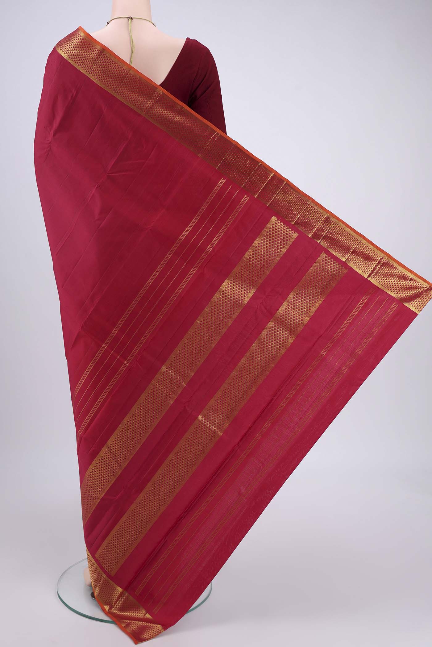 Flat view of Maroon Kanchipuram Silk Saree with Plain Body and Zari Border. 