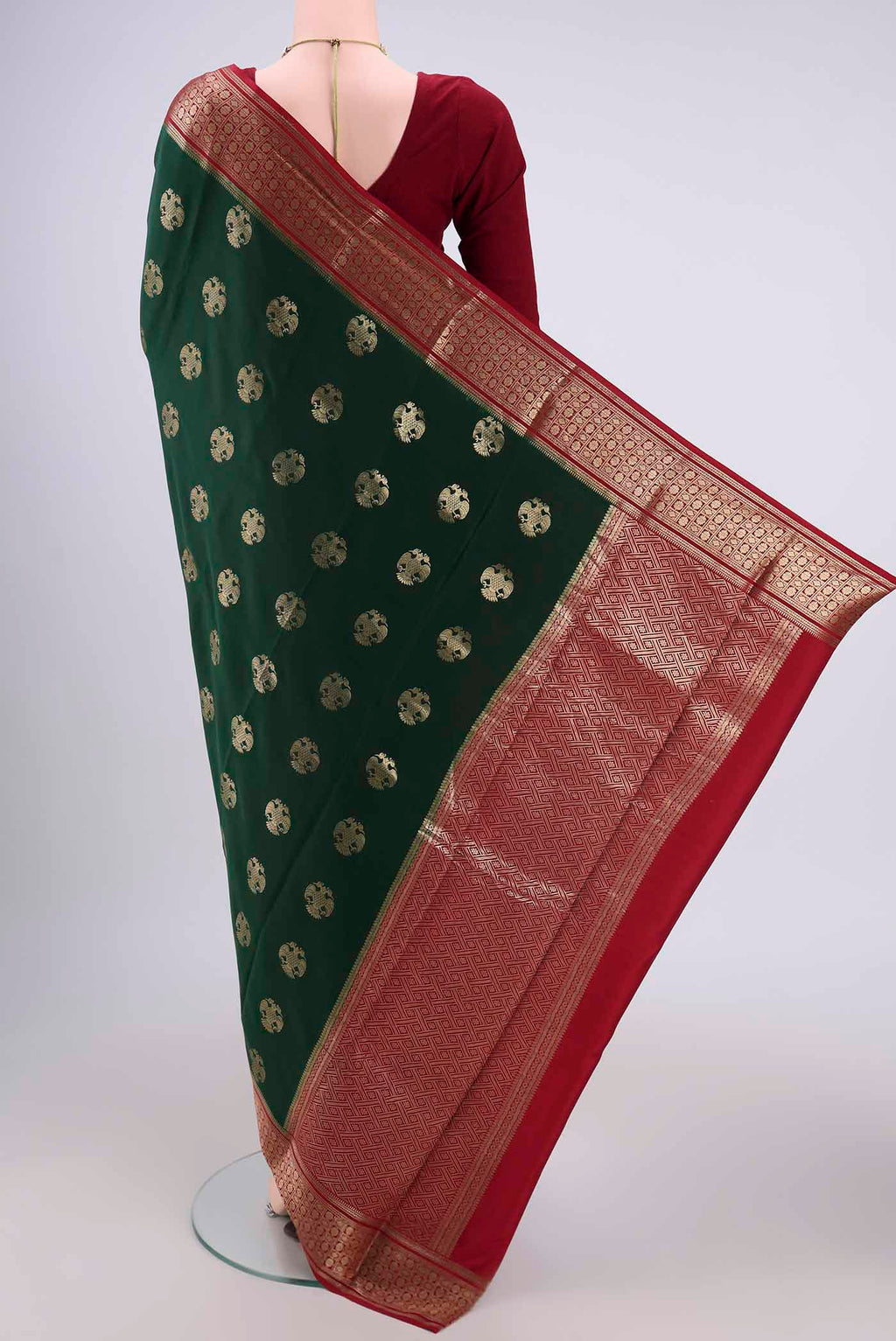 Flat view of Bottle Green Mysore Crepe Saree with Jacquard design on the body and Zari Border. 