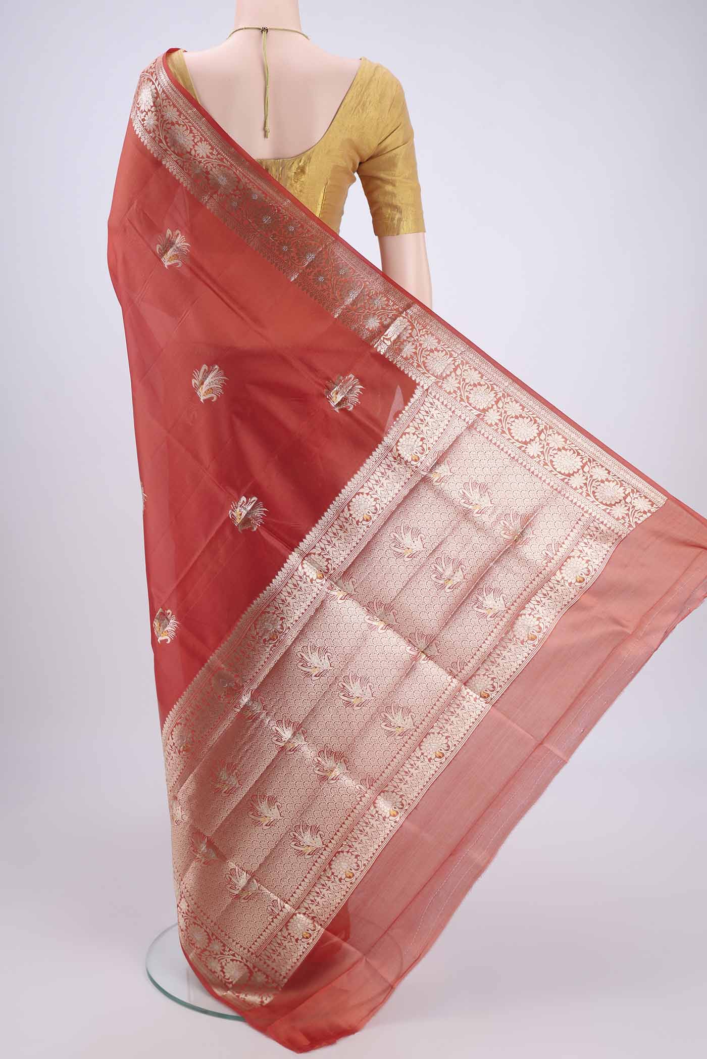 Flat view of Brick Orange Banarasi Raw Silk Saree with Zari Butta on the body and Zari Border. 