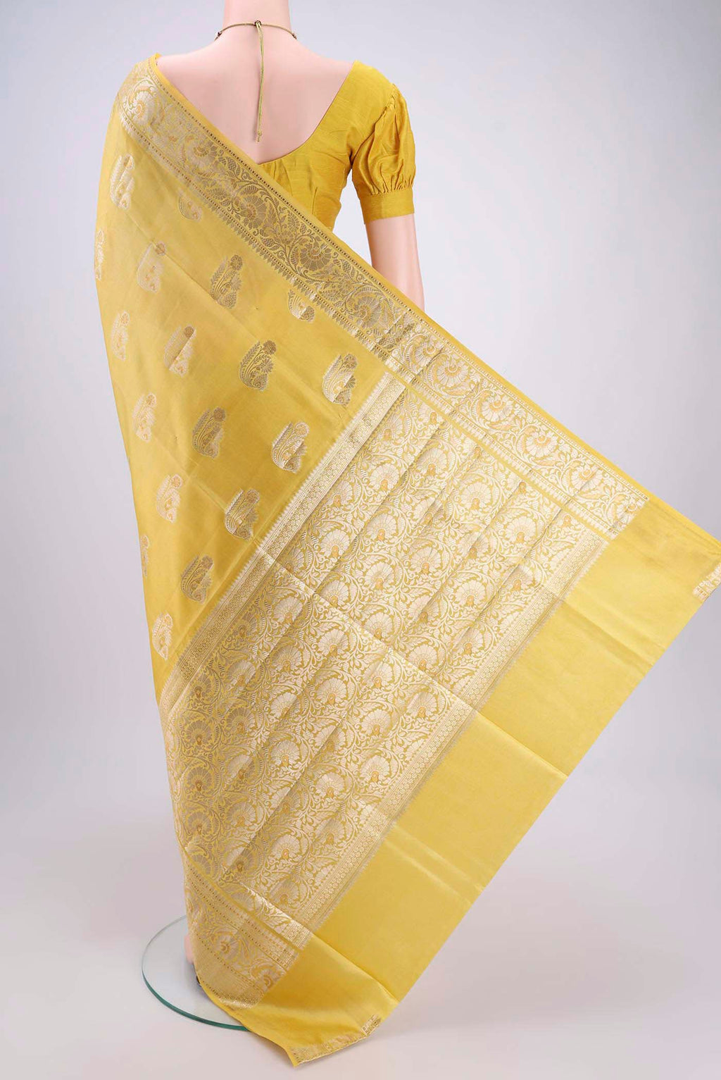 Flat view of Yellow Banarasi Raw Silk Saree with Zari Butta on the body and Zari Border. 