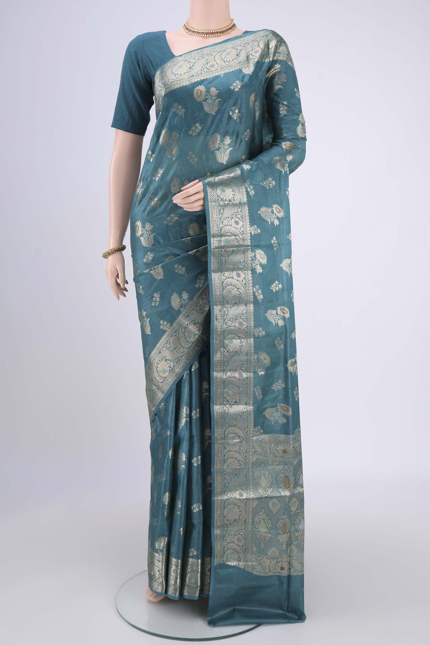 Turquoise Banarasi Tussar Silk Saree with Zari And Thread Butta on the body and Zari And Thread Border.  displayed on a mannequin