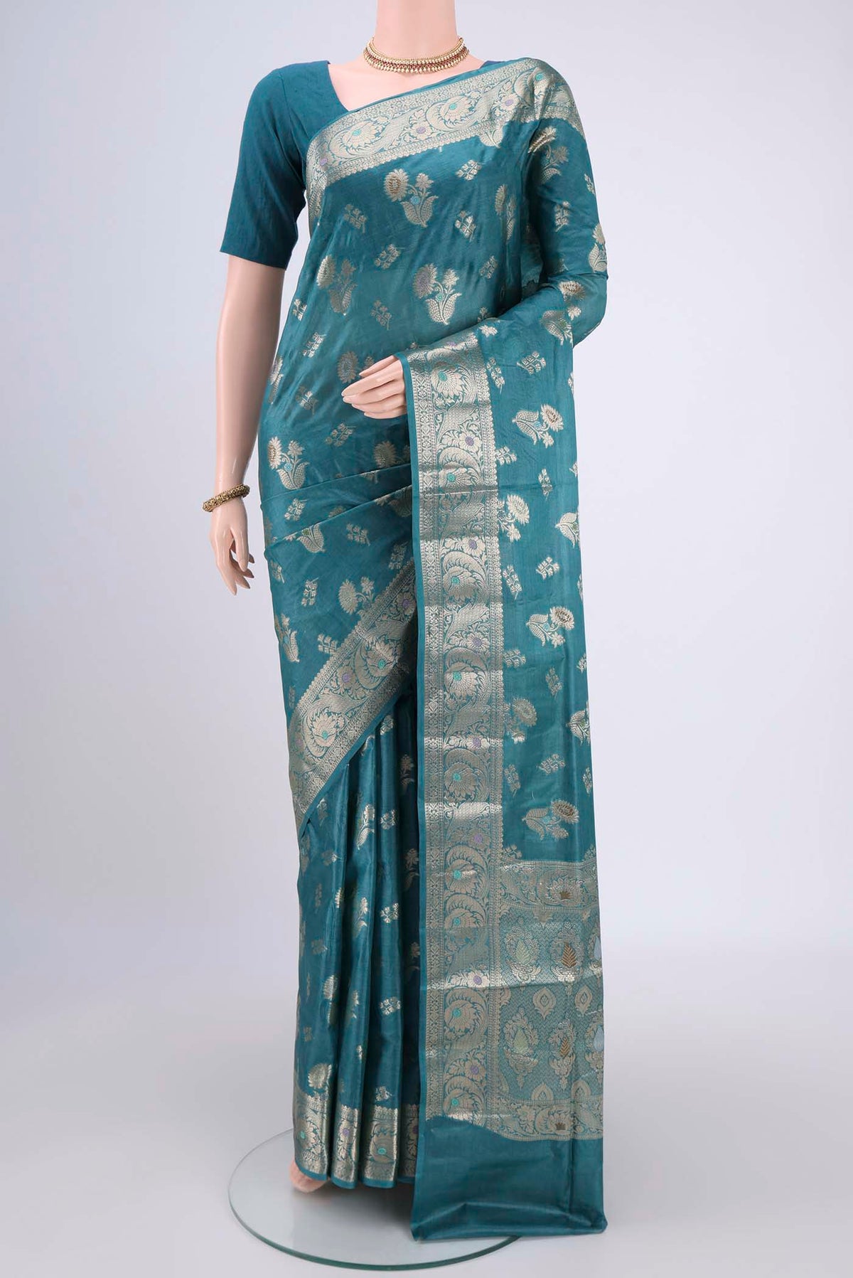 Turquoise Banarasi Tussar Silk Saree with Zari And Thread Butta on the body and Zari And Thread Border.  displayed on a mannequin