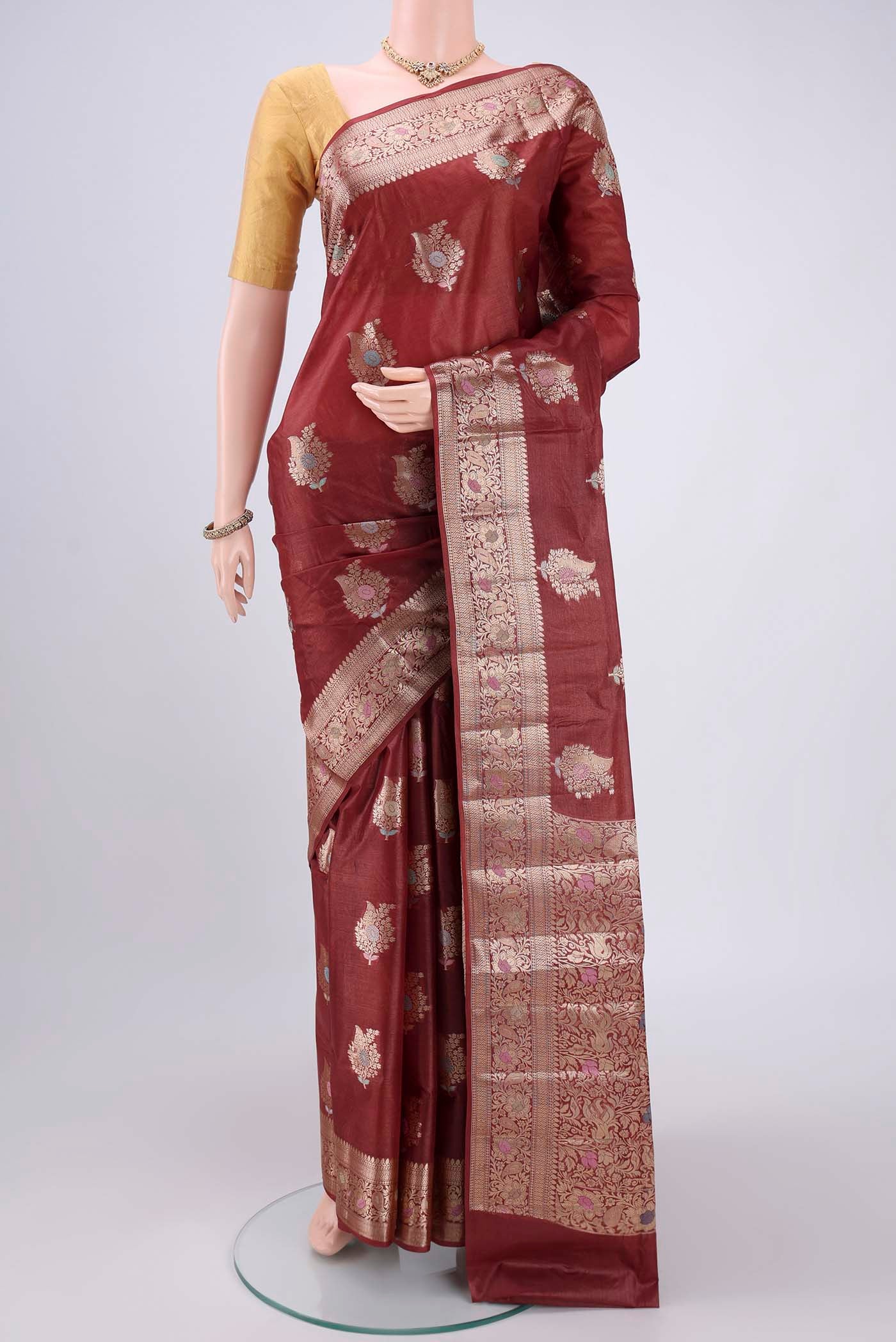 Brown Banarasi Tussar Silk Saree with Zari And Thread Butta on the body and Zari And Thread Border.  displayed on a mannequin