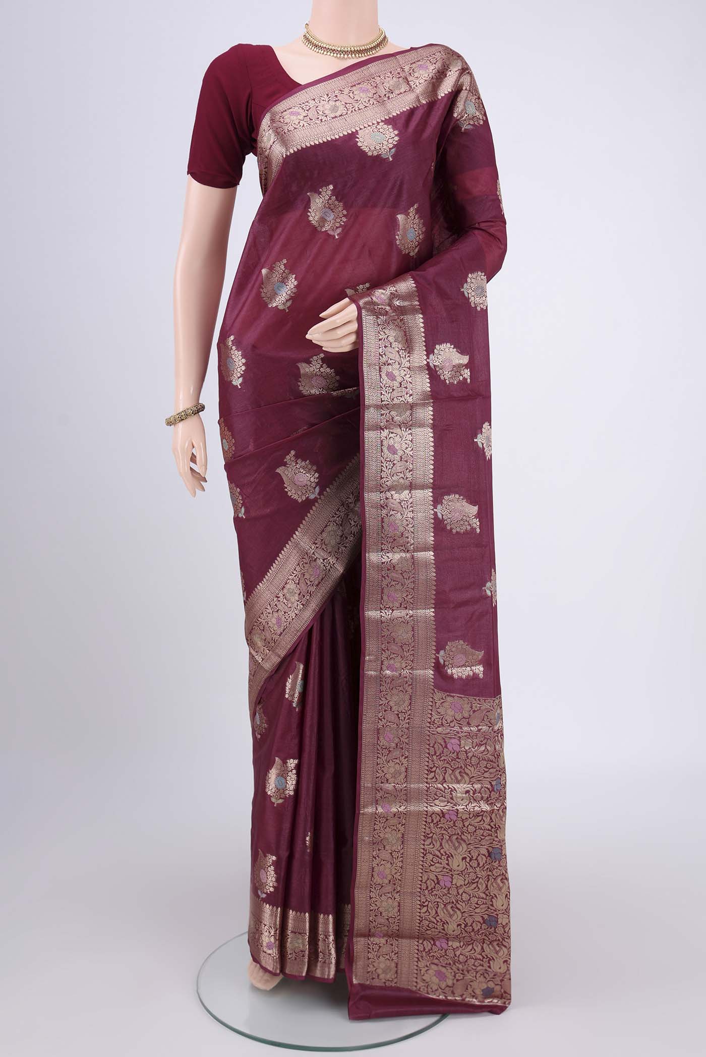 Magenta Banarasi Tussar Silk Saree with Zari And Thread Butta on the body and Zari And Thread Border.  displayed on a mannequin
