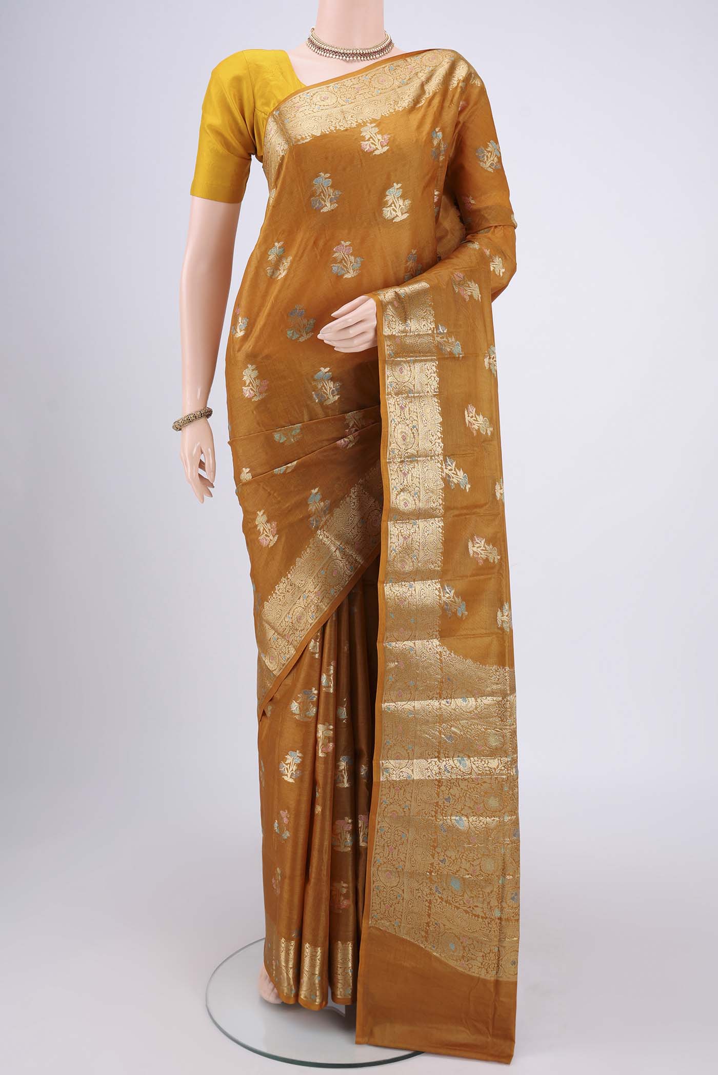 Mustard Banarasi Tussar Silk Saree with Zari And Thread Butta on the body and Zari And Thread Border.  displayed on a mannequin