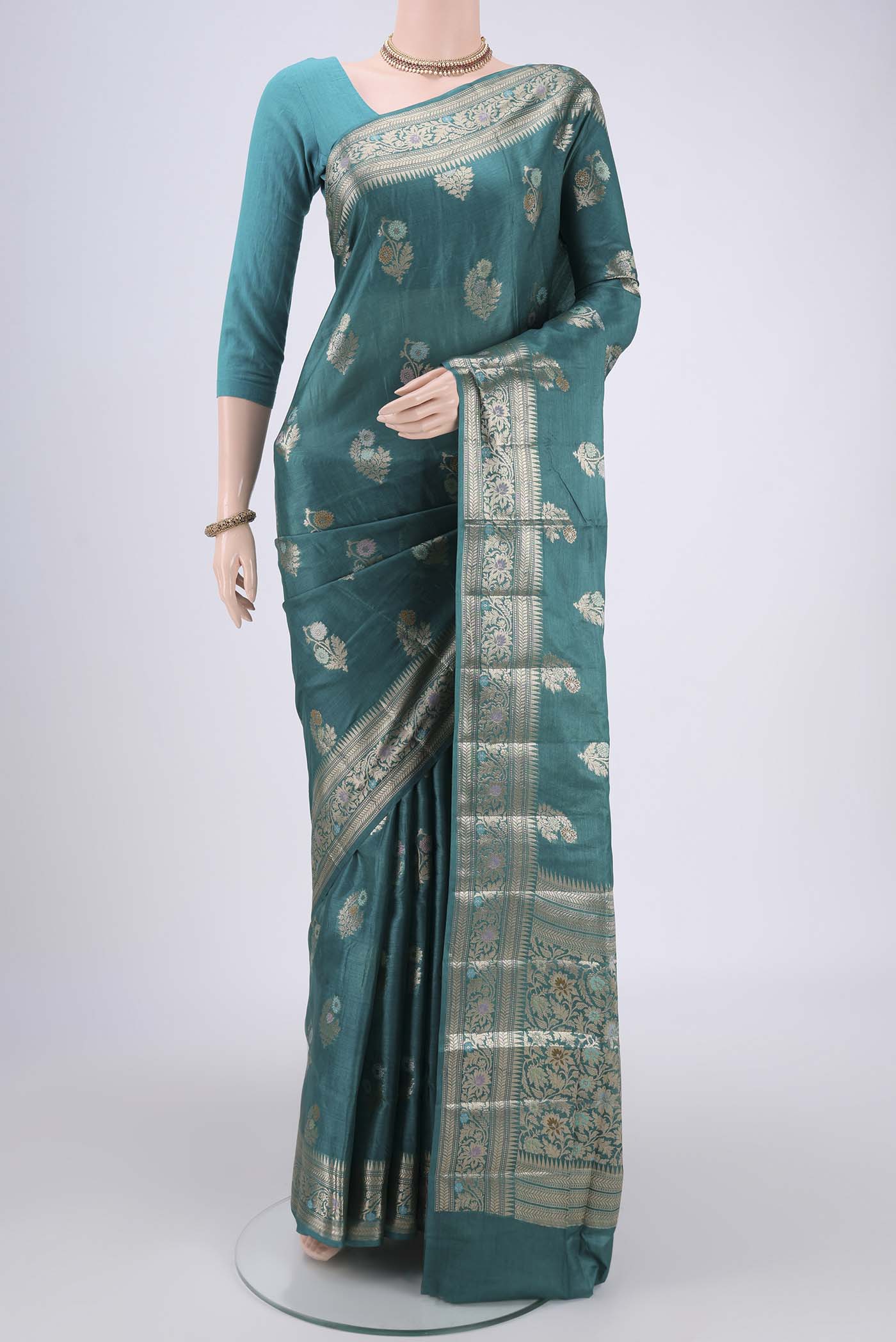 Turquoise Banarasi Tussar Silk Saree with Zari And Thread Butta on the body and Zari And Thread Border.  displayed on a mannequin