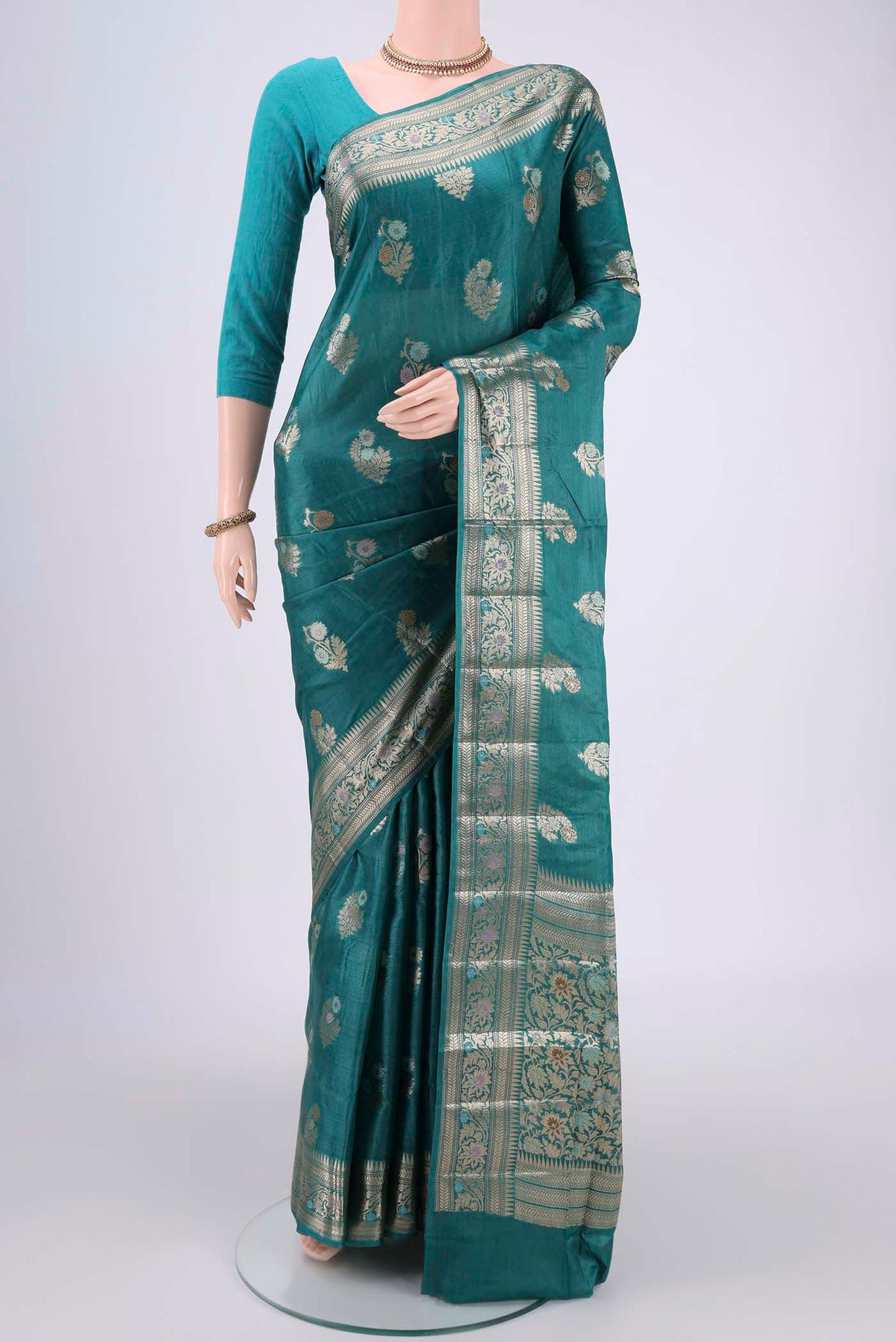 Turquoise Banarasi Tussar Silk Saree with Zari And Thread Butta on the body and Zari And Thread Border.  displayed on a mannequin
