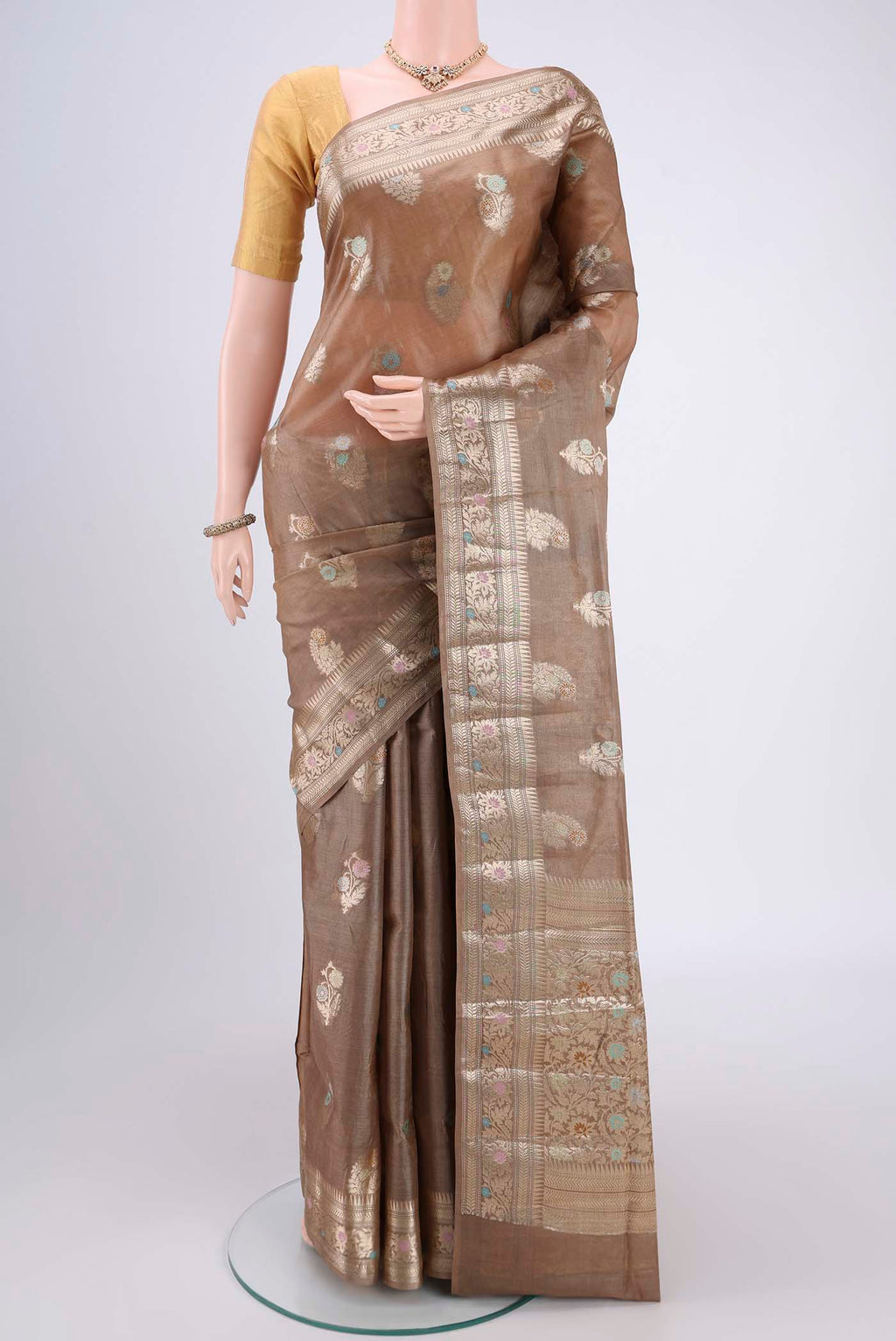 Coffee Brown Banarasi Tussar Silk Saree with Zari And Thread Butta on the body and Zari And Thread Border.  displayed on a mannequin