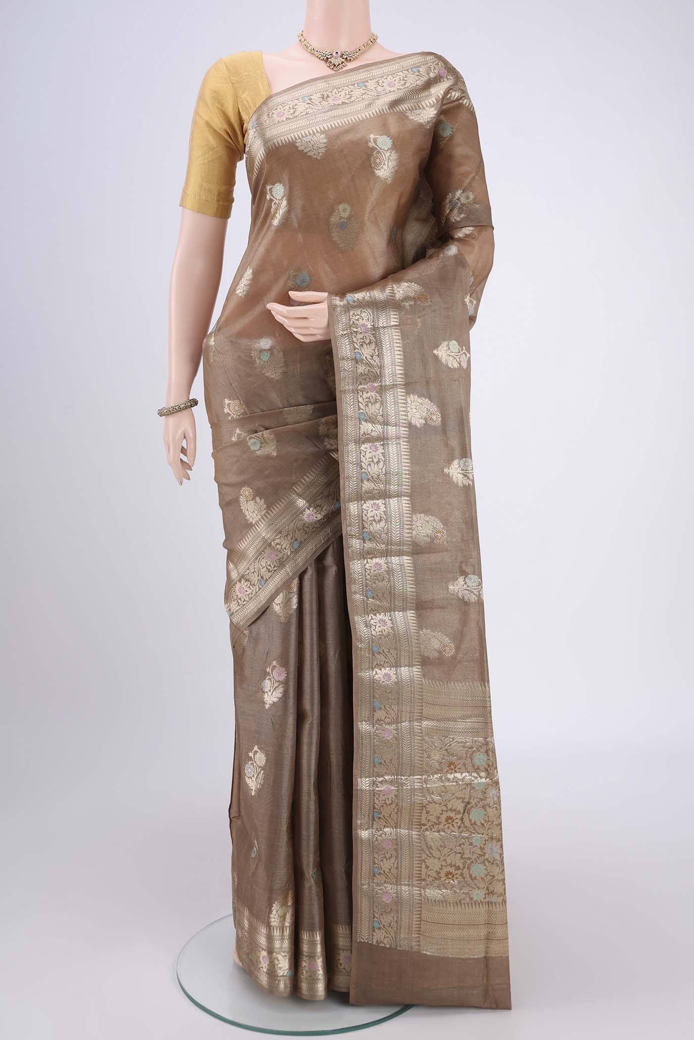 Coffee Brown Banarasi Tussar Silk Saree with Zari And Thread Butta on the body and Zari And Thread Border.  displayed on a mannequin