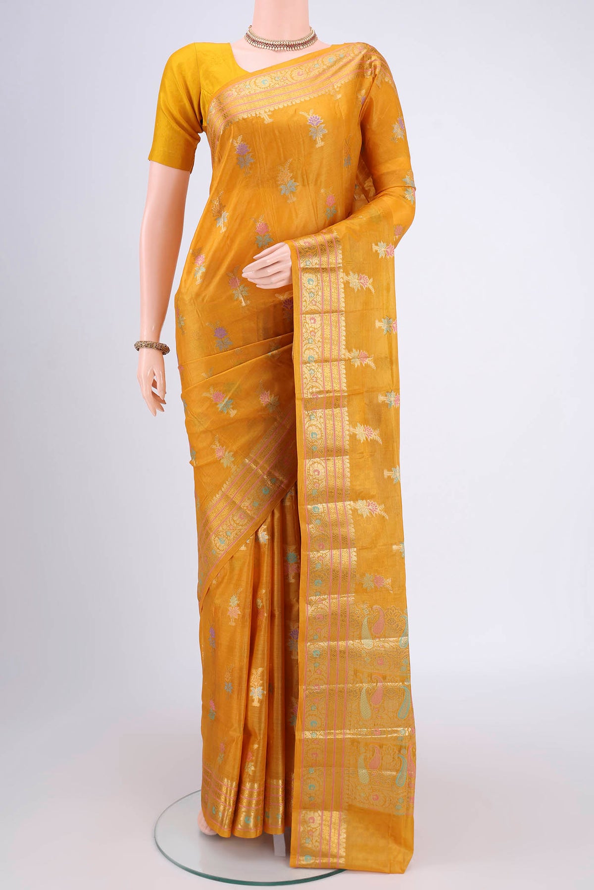 Yellow Banarasi Tussar Silk Saree with Zari And Thread Butta on the body and Zari And Thread Border.  displayed on a mannequin