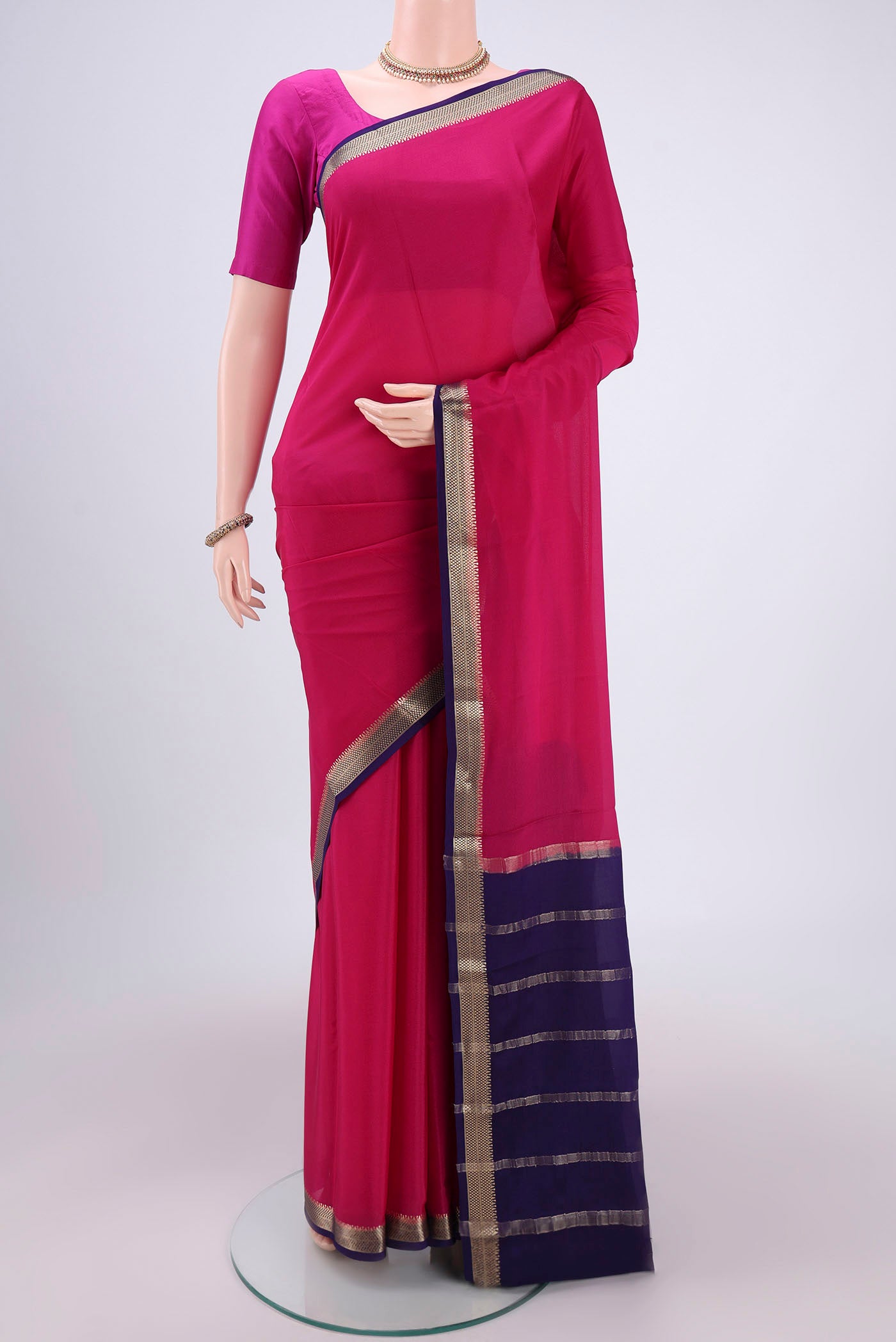 Rani Pink Mysore Crepe Saree with Plain Body and Zari Border.  displayed on a mannequin