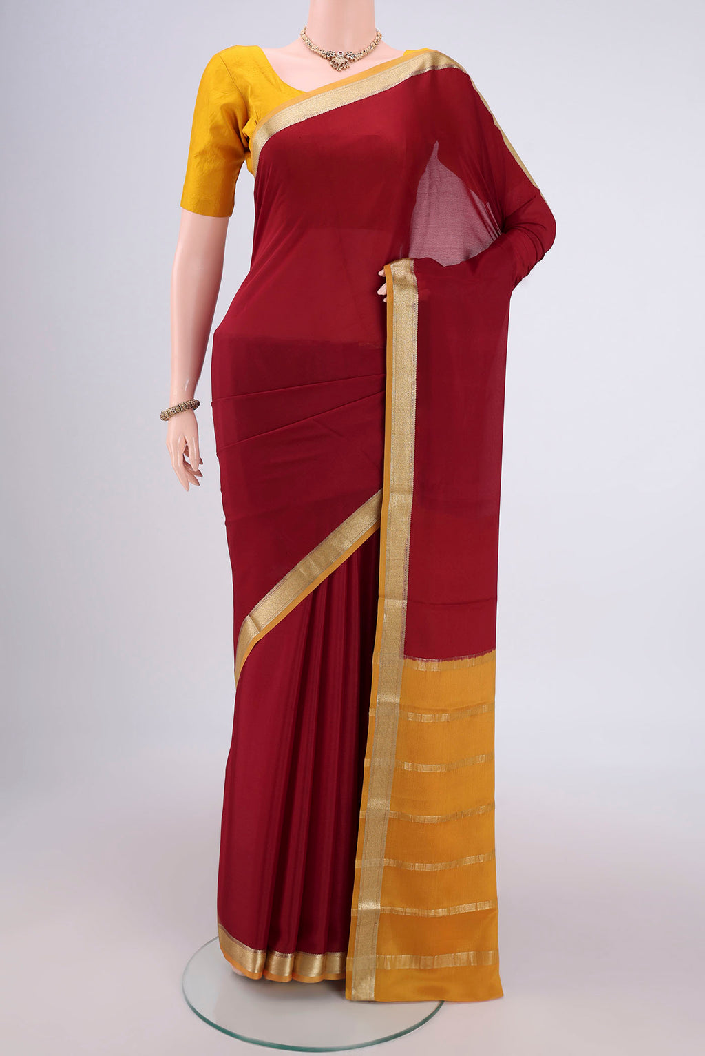 Maroon Mysore Crepe Saree with Plain Body and Zari Border.  displayed on a mannequin
