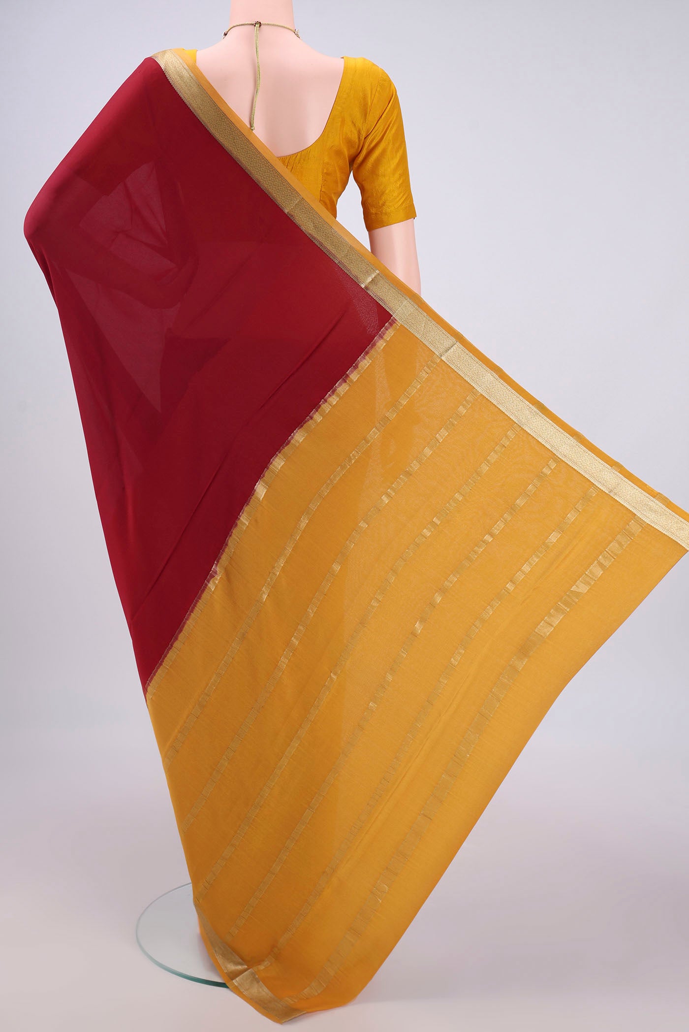 Flat view of Maroon Mysore Crepe Saree with Plain Body and Zari Border. 