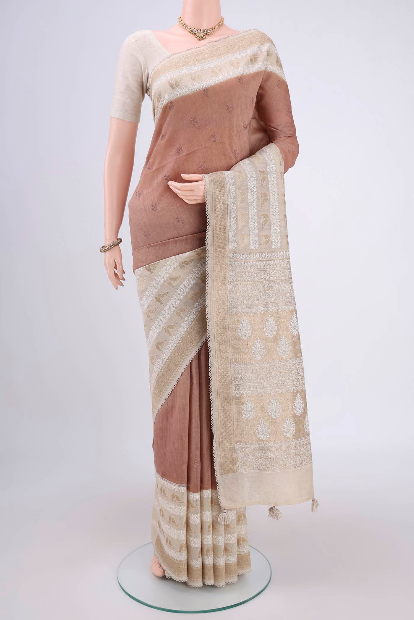 Brown Tussar Silk Saree with Thread Butta on the body and Thread Border.  displayed on a mannequin