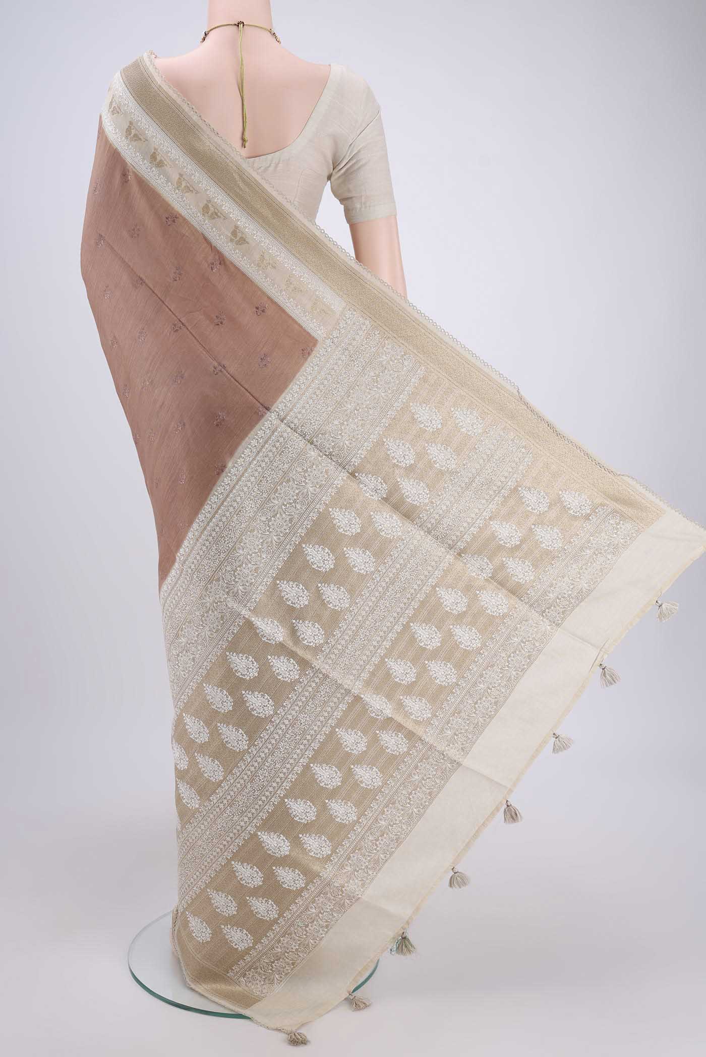 Flat view of Brown Tussar Silk Saree with Thread Butta on the body and Thread Border. 