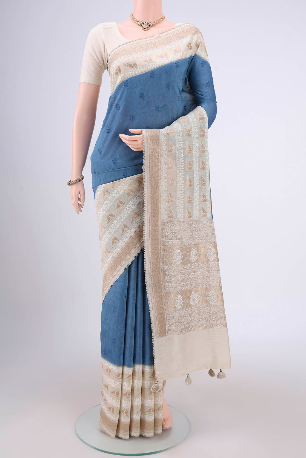 Blue MP Tussar Saree with Embroidery on the body and Zari Border.  displayed on a mannequin