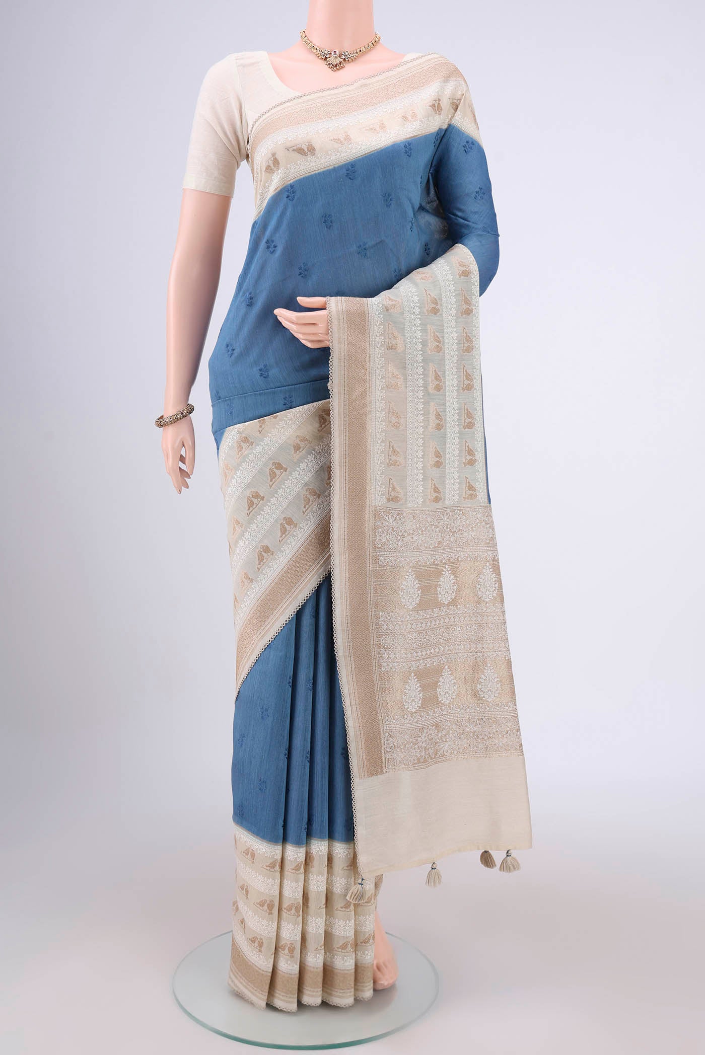 Blue MP Tussar Saree with Embroidery on the body and Zari Border.  displayed on a mannequin
