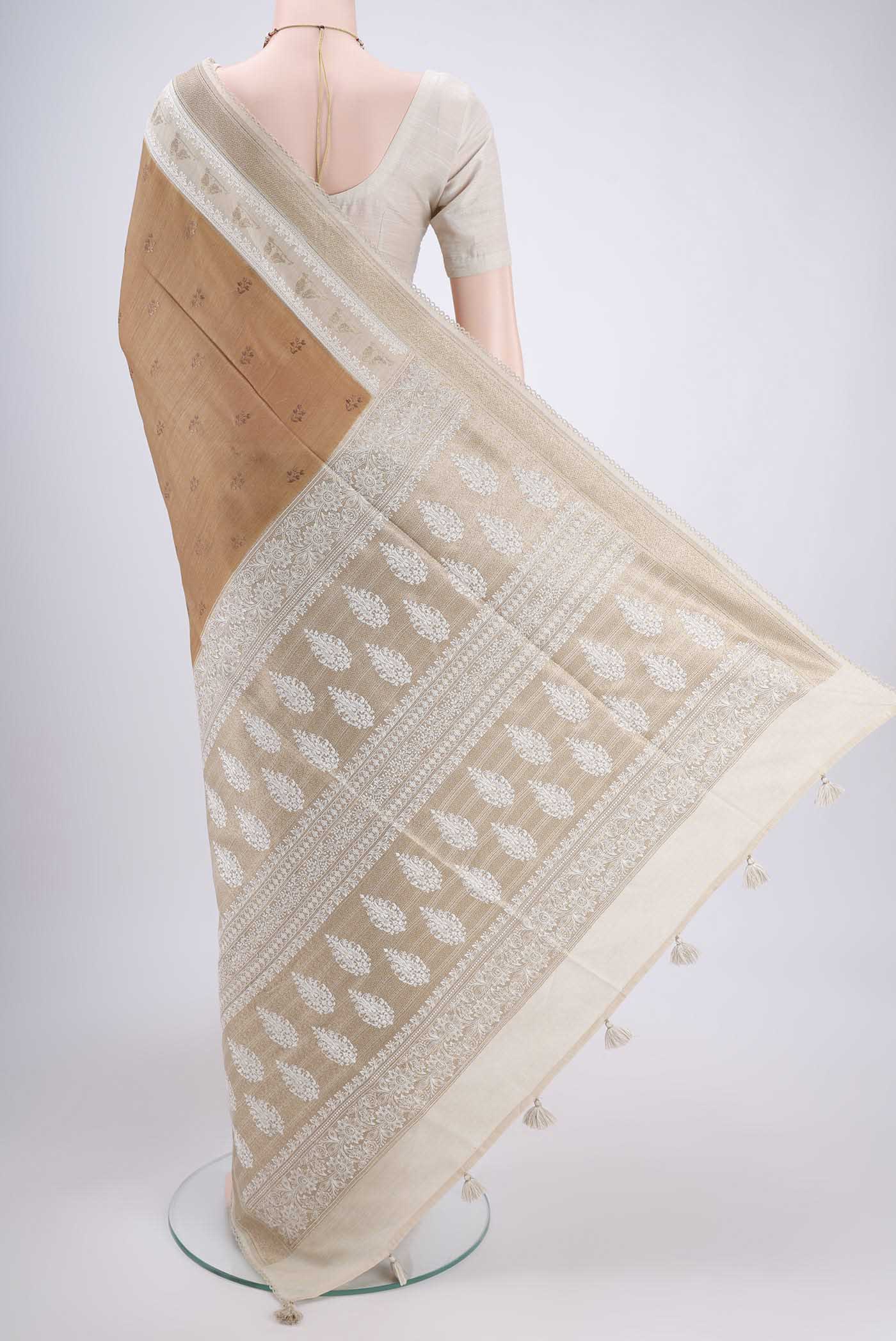 Flat view of Dark Beige Tussar Silk Saree with Thread Butta on the body and Zari Border. 
