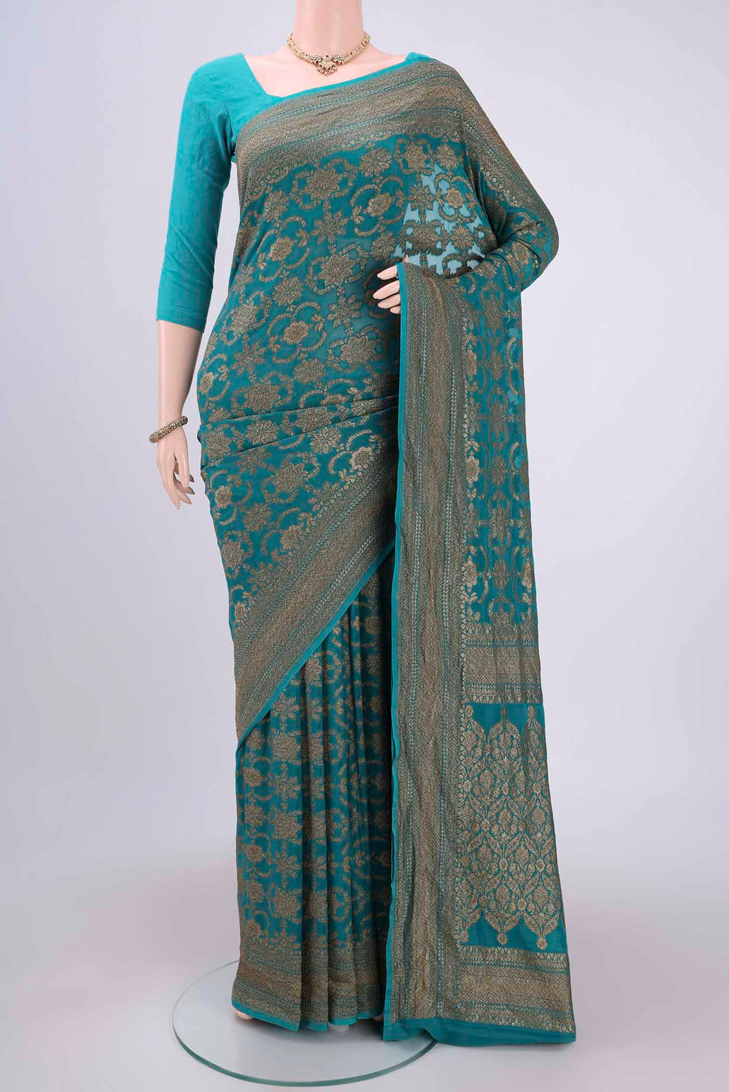Sea Green Banarasi Georgette Saree with Zari Brocade on the body and Zari Border.  displayed on a mannequin