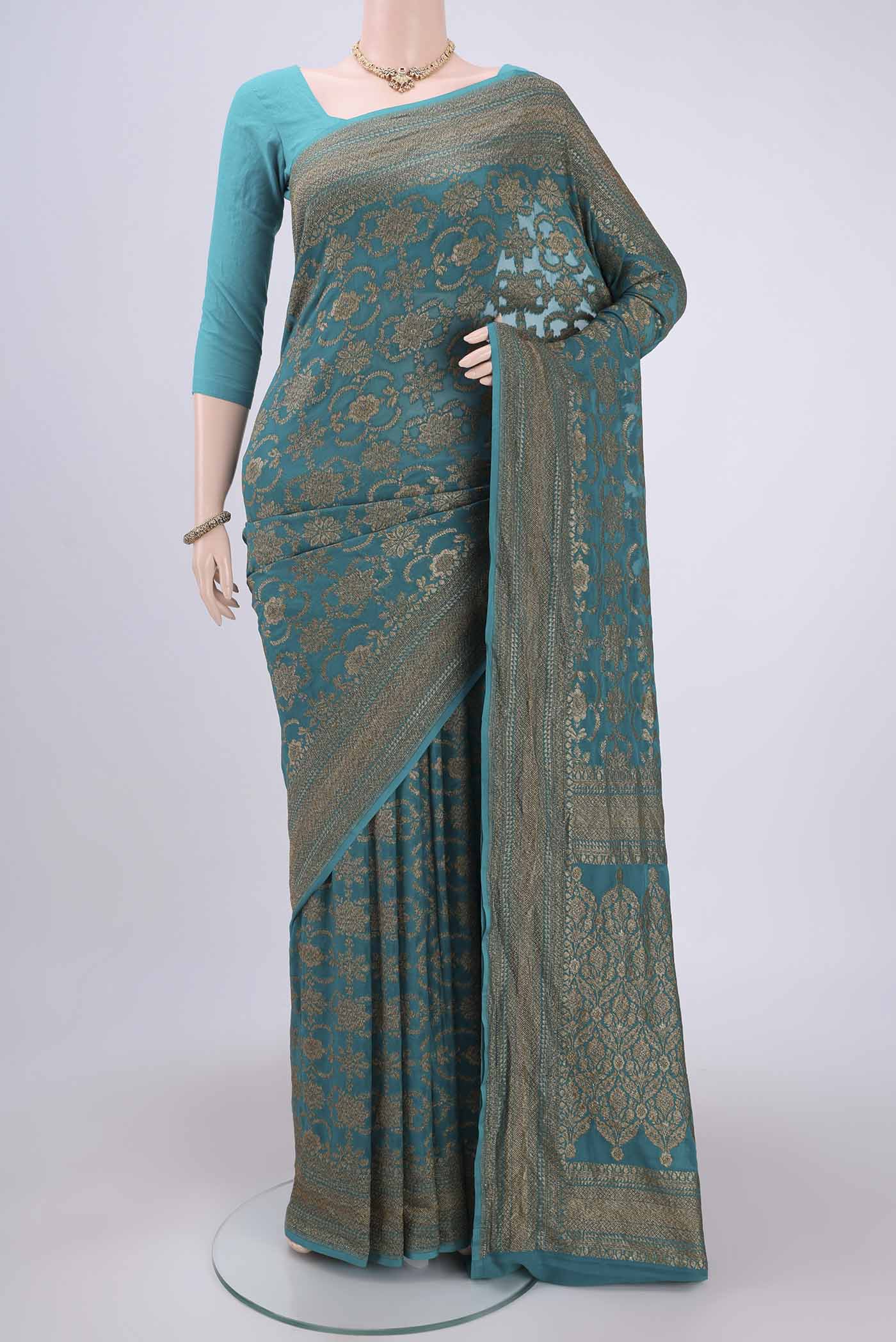 Sea Green Banarasi Georgette Saree with Zari Brocade on the body and Zari Border.  displayed on a mannequin