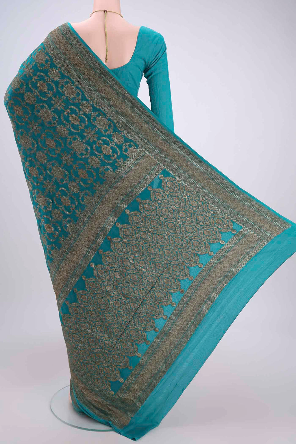 Flat view of Sea Green Banarasi Georgette Saree with Zari Brocade on the body and Zari Border. 