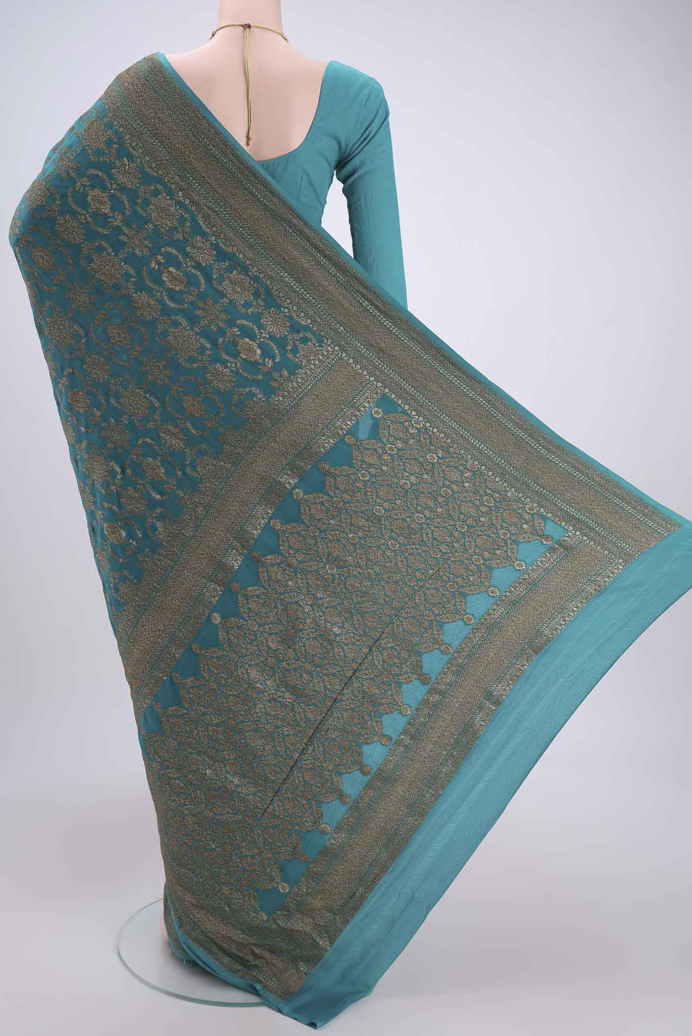 Flat view of Sea Green Banarasi Georgette Saree with Zari Brocade on the body and Zari Border. 