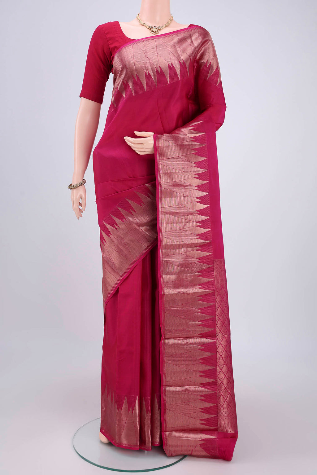 Pink Kanchipuram Silk Saree with Zari Butta on the body and Zari Border.  displayed on a mannequin