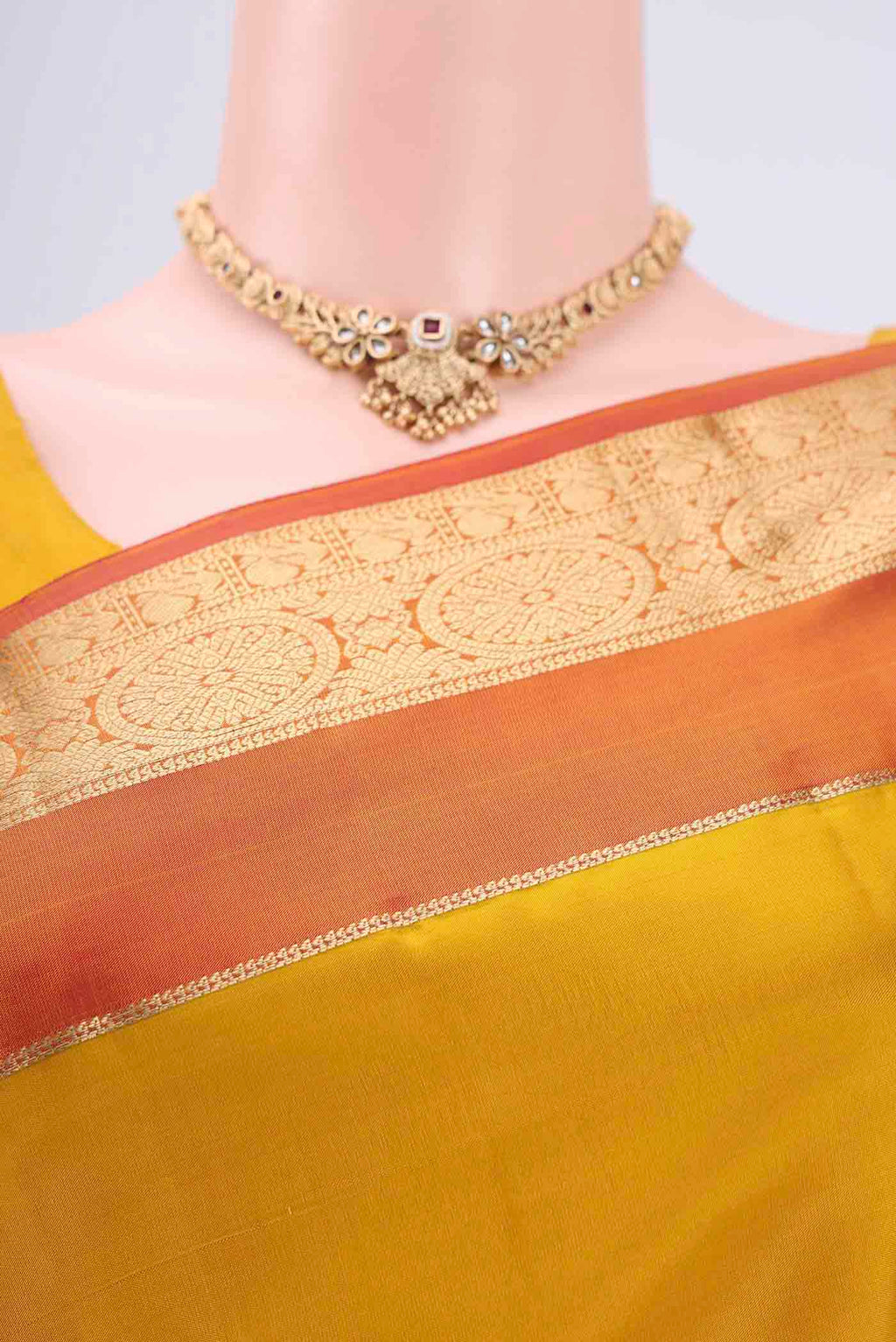 Border image of Yellow Kanchipuram Silk Saree with Zari Butta on the body and Zari Border. 