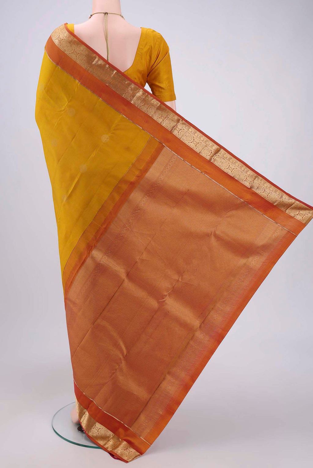 Flat view of Yellow Kanchipuram Silk Saree with Zari Butta on the body and Zari Border. 