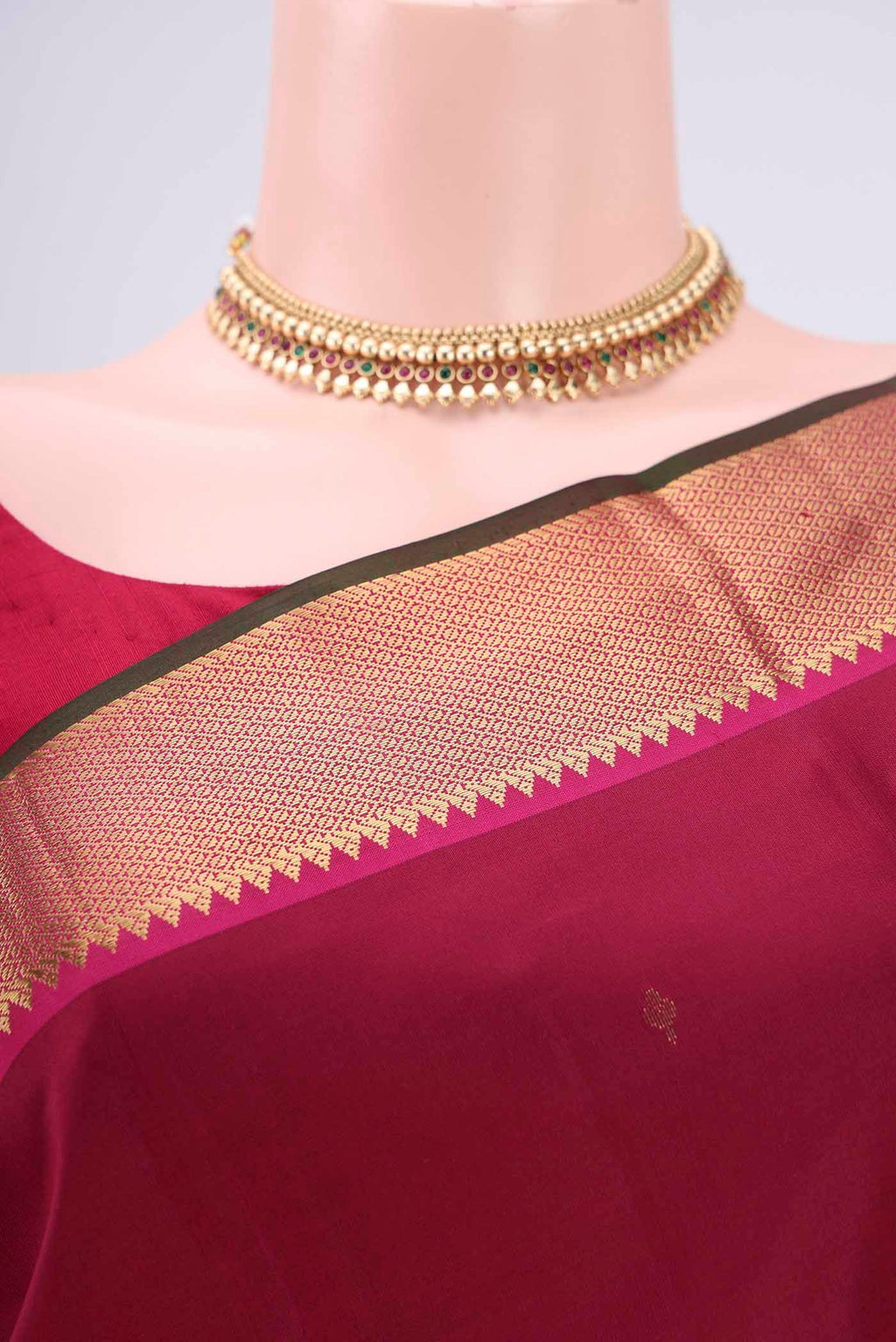 Border image of Rust Kanjivaram Silk Saree with Zari Butta on the body and Zari Border. 