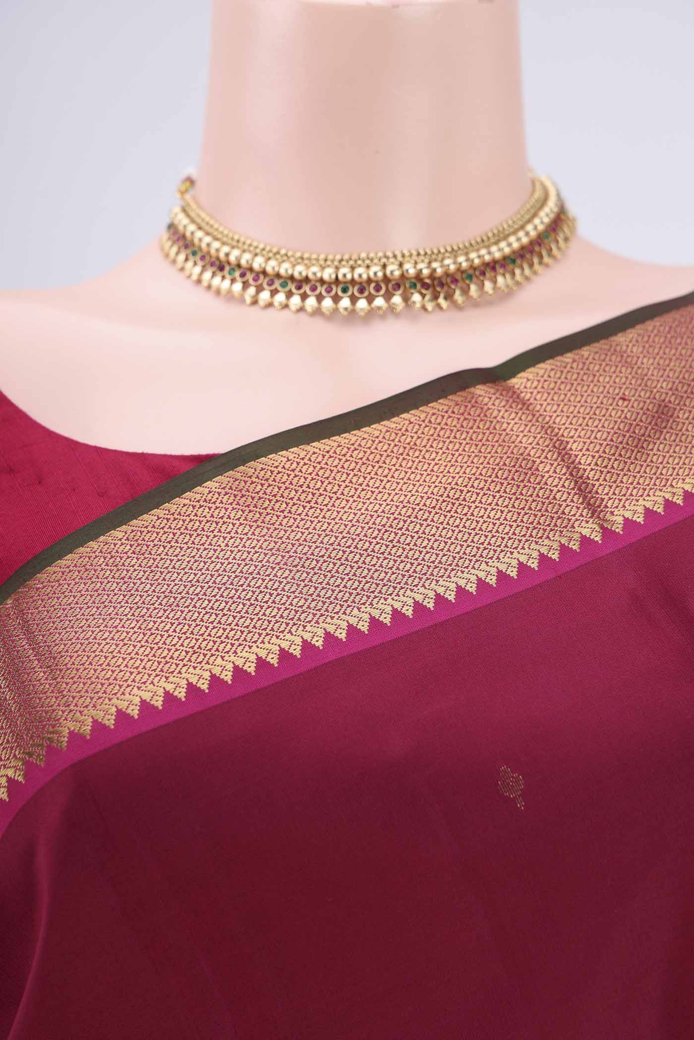 Border image of Rust Kanjivaram Silk Saree with Zari Butta on the body and Zari Border. 