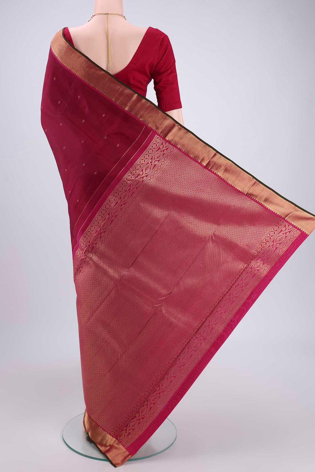 Flat view of Rust Kanjivaram Silk Saree with Zari Butta on the body and Zari Border. 